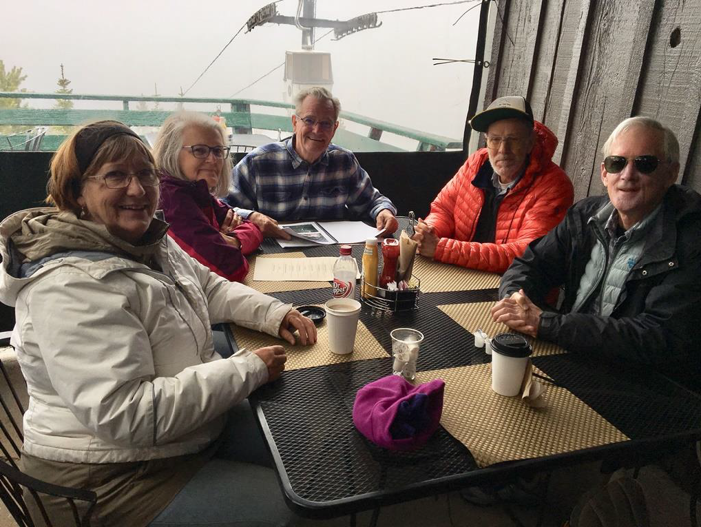Field trip participants Dawn Juliano, Mary and Charlie Raymond, and Woody English chat with Dave Jensen (orange coat) while waiting for the clouds to lift.
