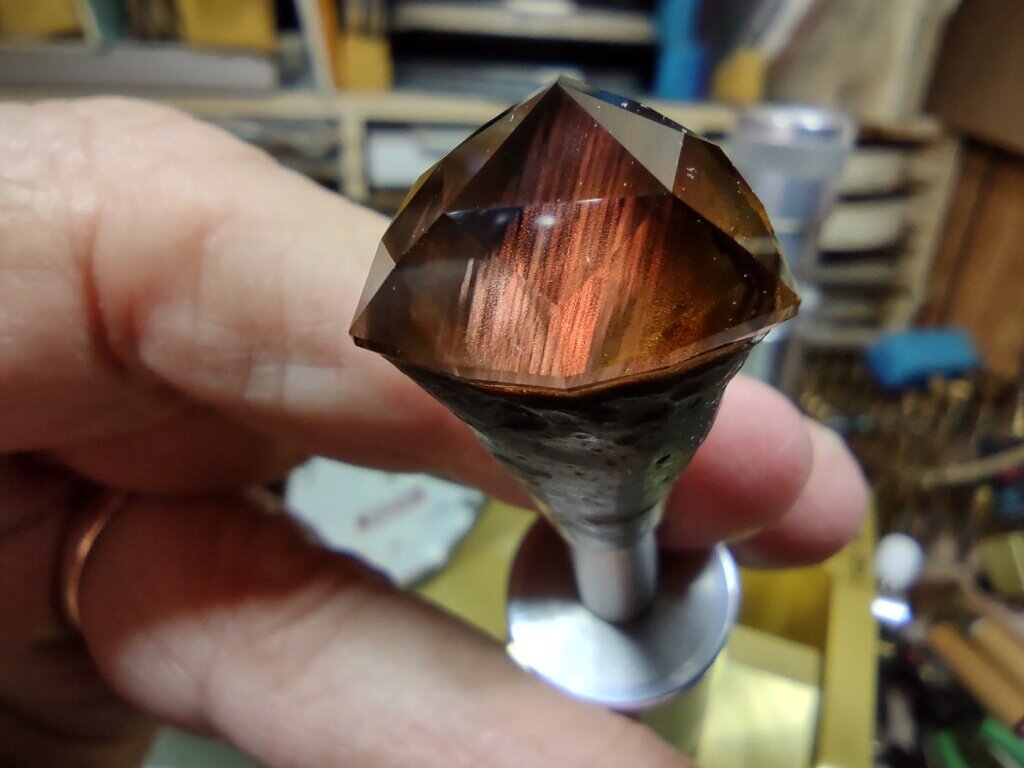  A lovely sunstone with exquisite schiller is being faceted 