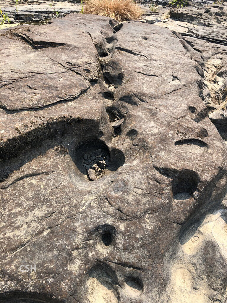  The “captive” pebbles wear circular holes in the bedrock. Many of the pebbles were basalt. 