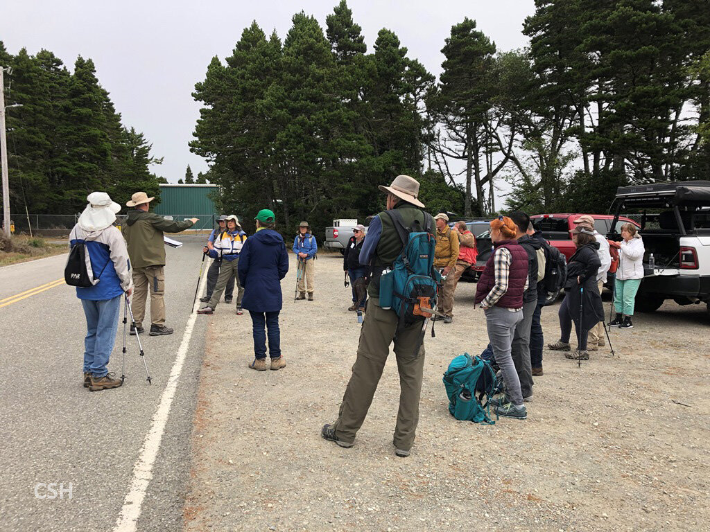  The group meets with Frank Hladky near the Cape Blanco State Airport for the Day 4 trip to Blacklock Point. 