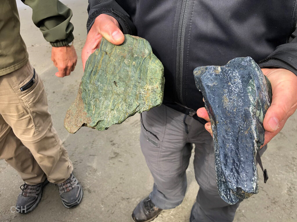 Two very different appearing chunks of blueschist exhibiting the minerals lawsonite on the left and glaucophane on the right. 