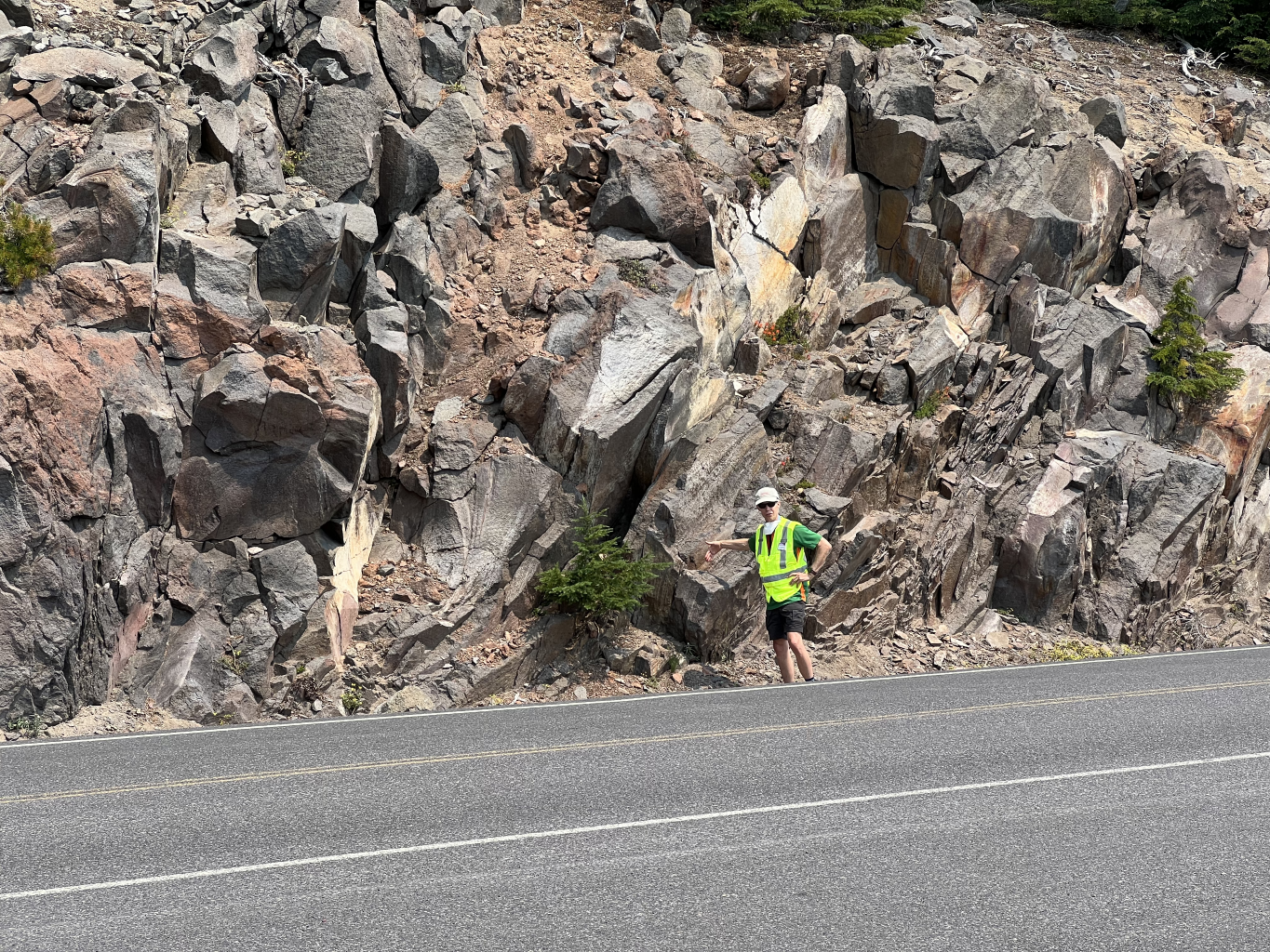  Lee points out the intact dacite flow in the roadcut on the crater side of the rim road at Stop 6. The 50,000-year-old Watchman Flow has a very glassy texture. 