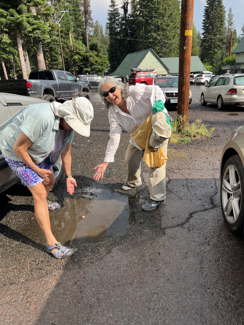  Sue and Sheila demonstrate that pumice does float in the parking lot puddle. 