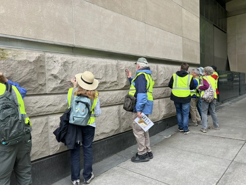  Participants engage in studying the limestone blocks 