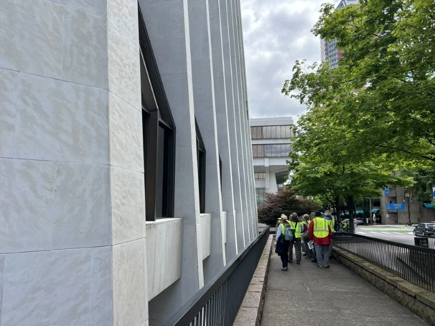  GSOC group examines granite wall at base of the building 
