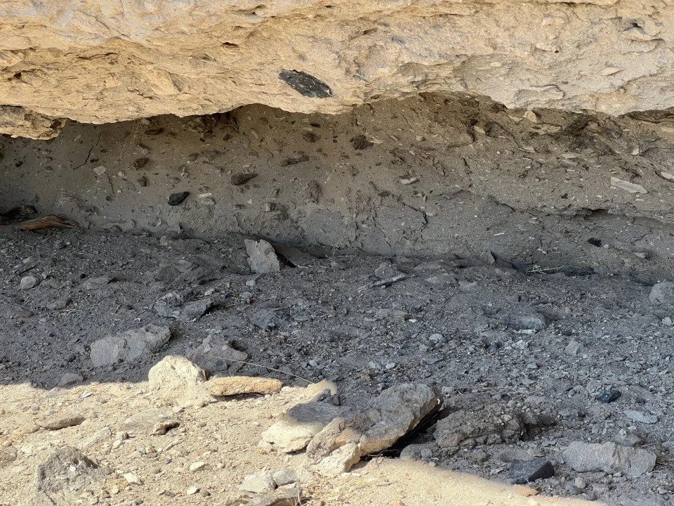  Fiamme (black lenses) form at the base where the overburden compacts the pumice. 