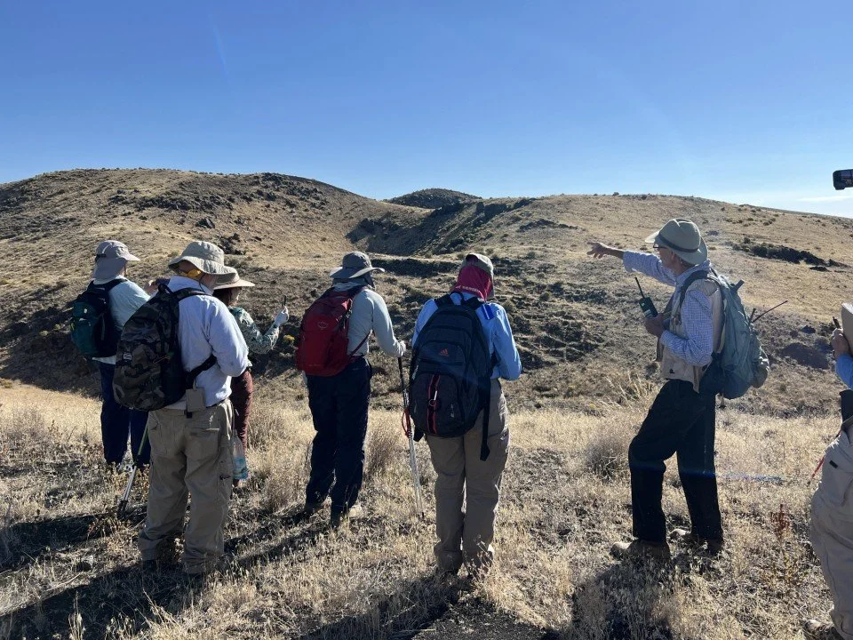 The group looks across the boundary trough to the explosion craters. 
