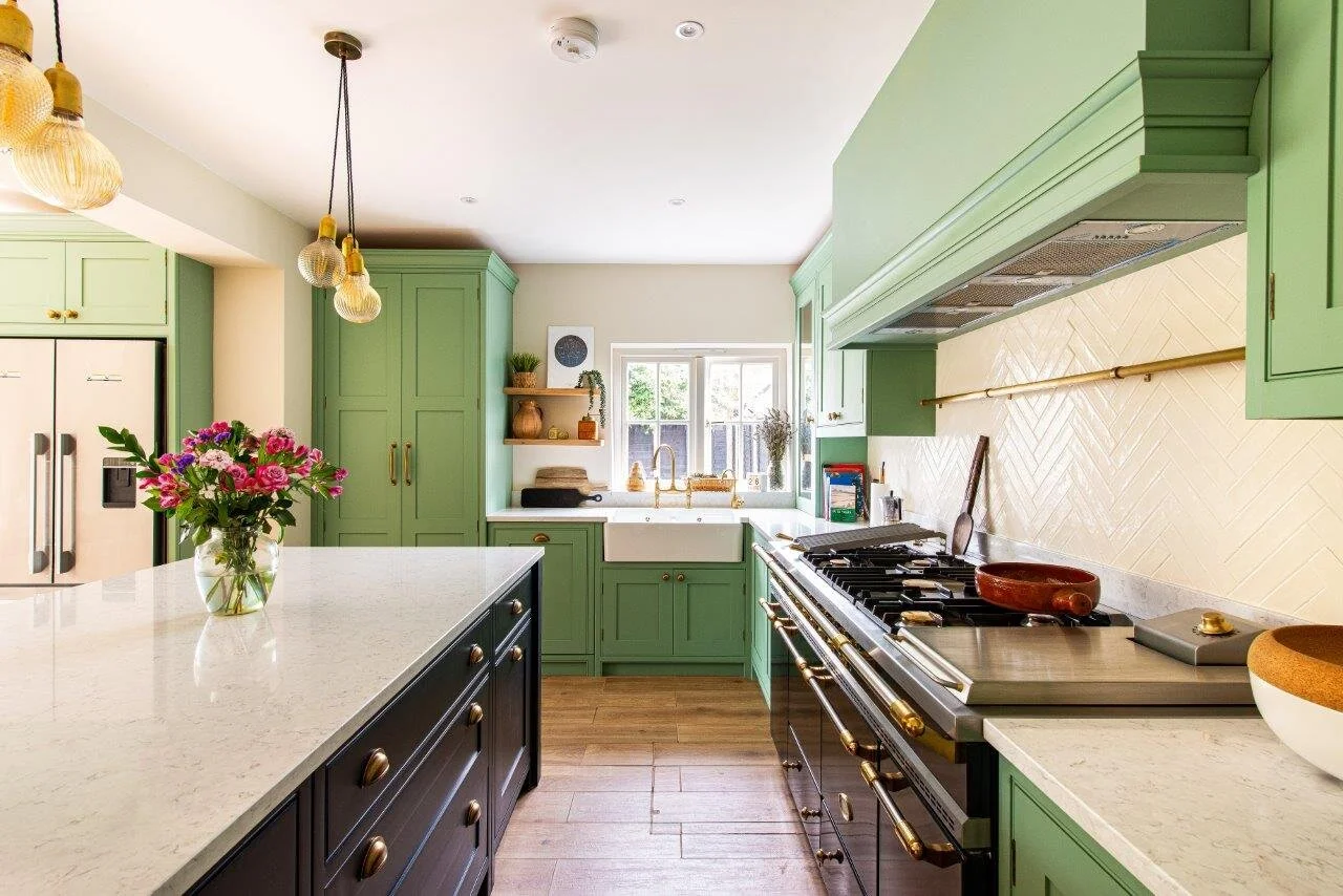 Green and black shaker kitchen with range cooker and butler sink