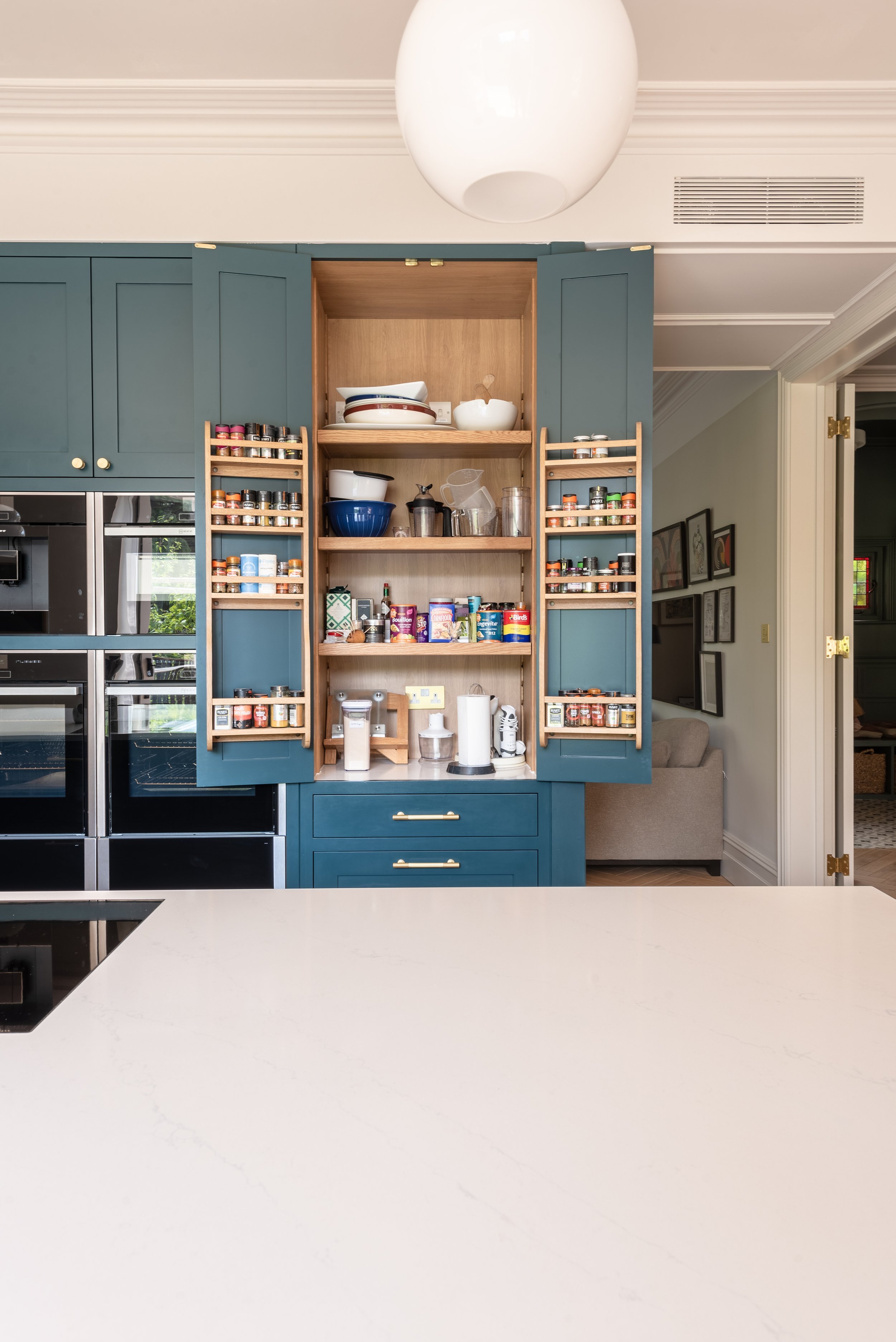 Large pantry larder in dark blue kitchen by Herringbone