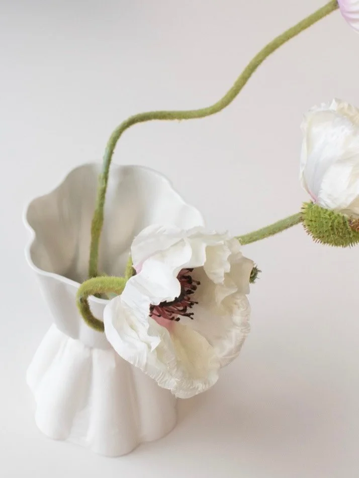 Meet TALIO! A vase with so much character that it works even without flowers. It has a tight waist (or a tight talio as one would say in the Esperanto language) connecting the two identical body shapes. It looks inflated and deflated at the same time