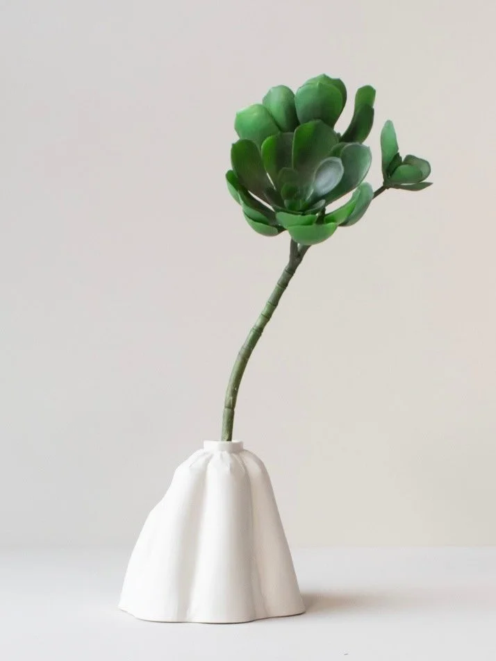 JUPO is a sculptural vase with a neck that gathers the flowers nicely. It has a soft feeling of voluminous textiles. The texture and shape gives it a feeling of something inflated and deflated at the same time, somewhere between fabric and paper.

JU