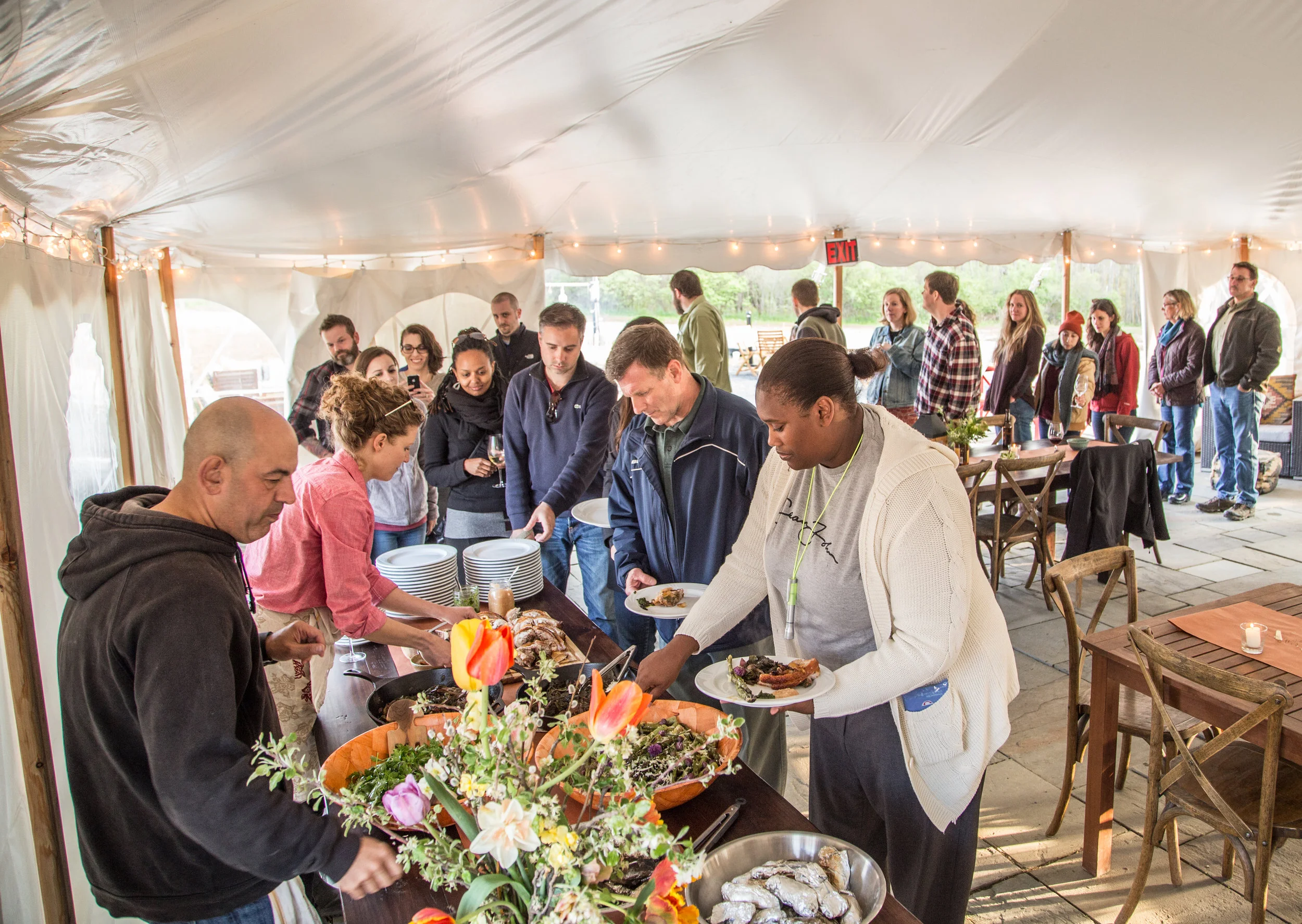 Serving up a campfire feast with celebrity chef, Simon Majumdar, on his #GiveUsABedIllCookYouDinner tour. Photo by Kristen Kellogg (borderfreetravels.com)