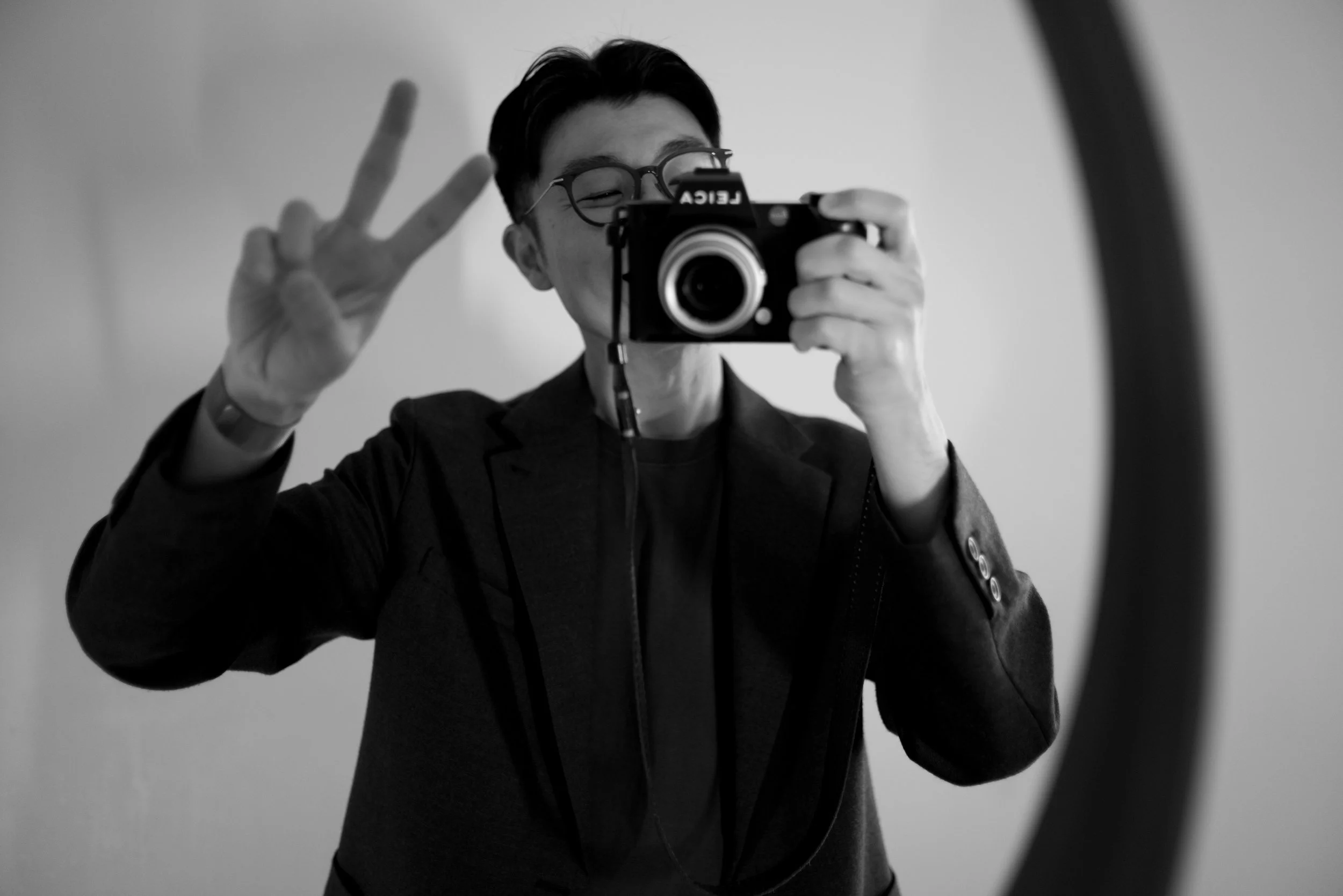 Self-portrait of Vancouver wedding photographer John Yoo with a Leica camera.