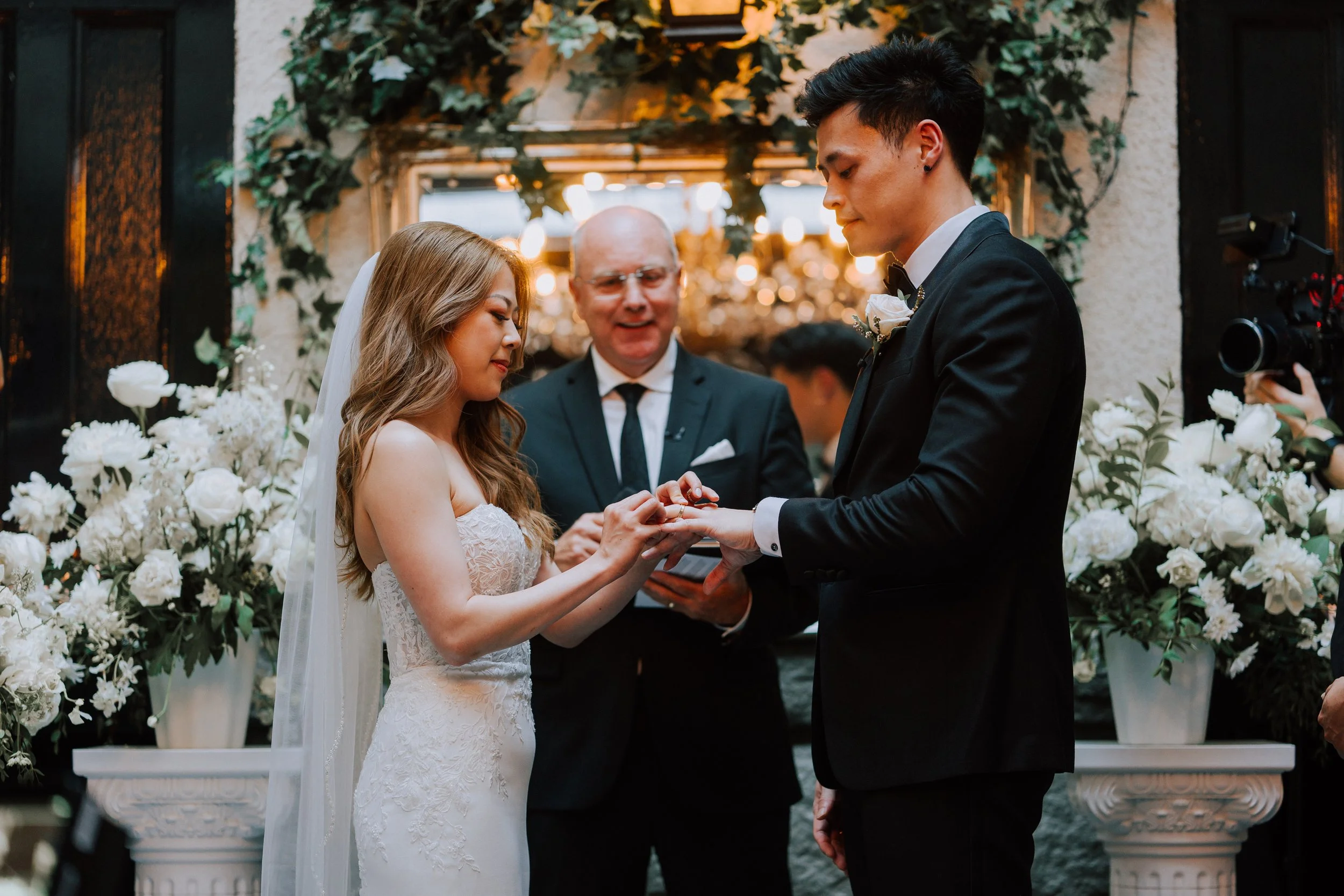 Bride and groom exchanging rings during their wedding ceremony at Brix & Mortar in Yaletown, Vancouver.