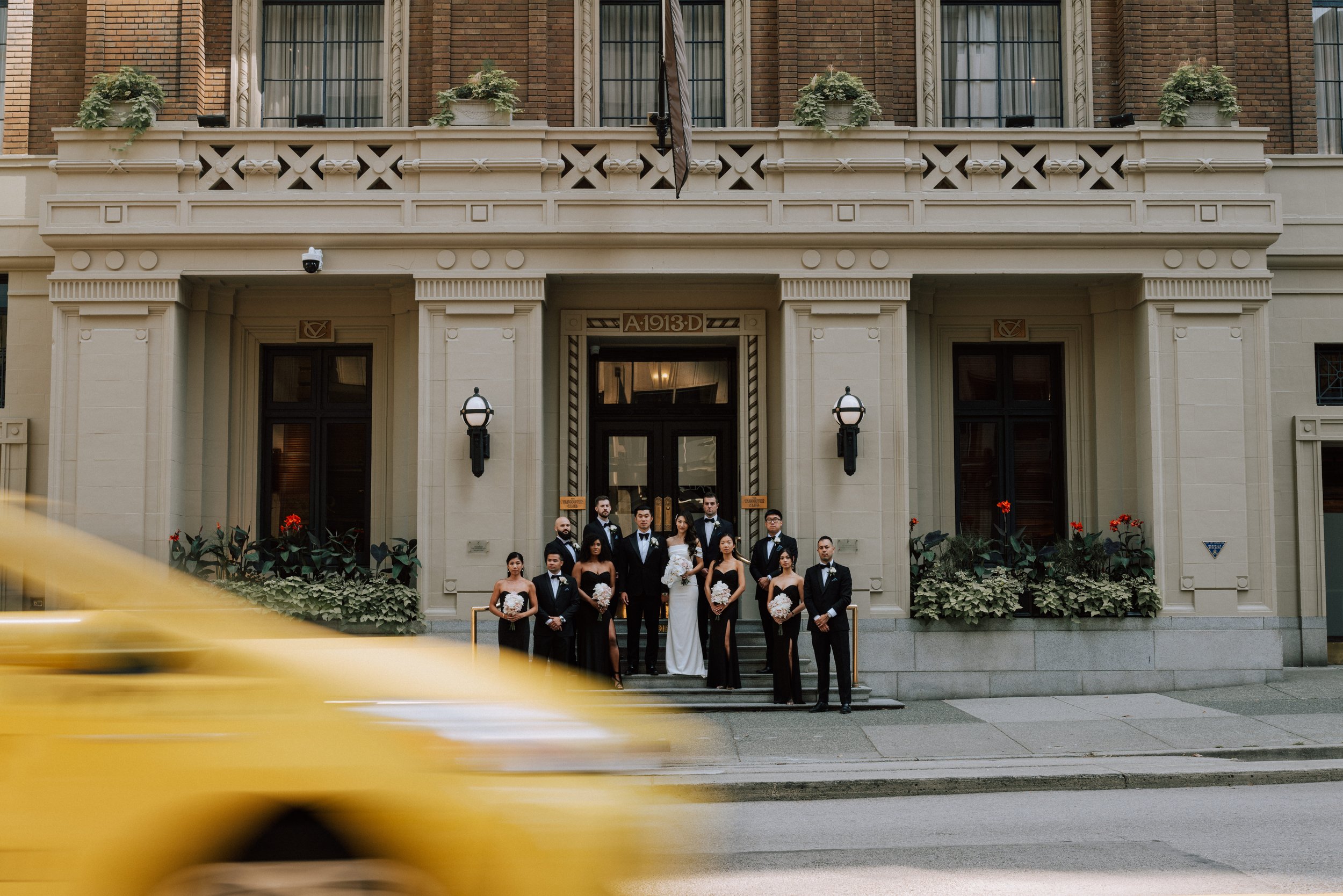 Wedding party portrait outside The Vancouver Club wedding venue in Downtown Vancouver.