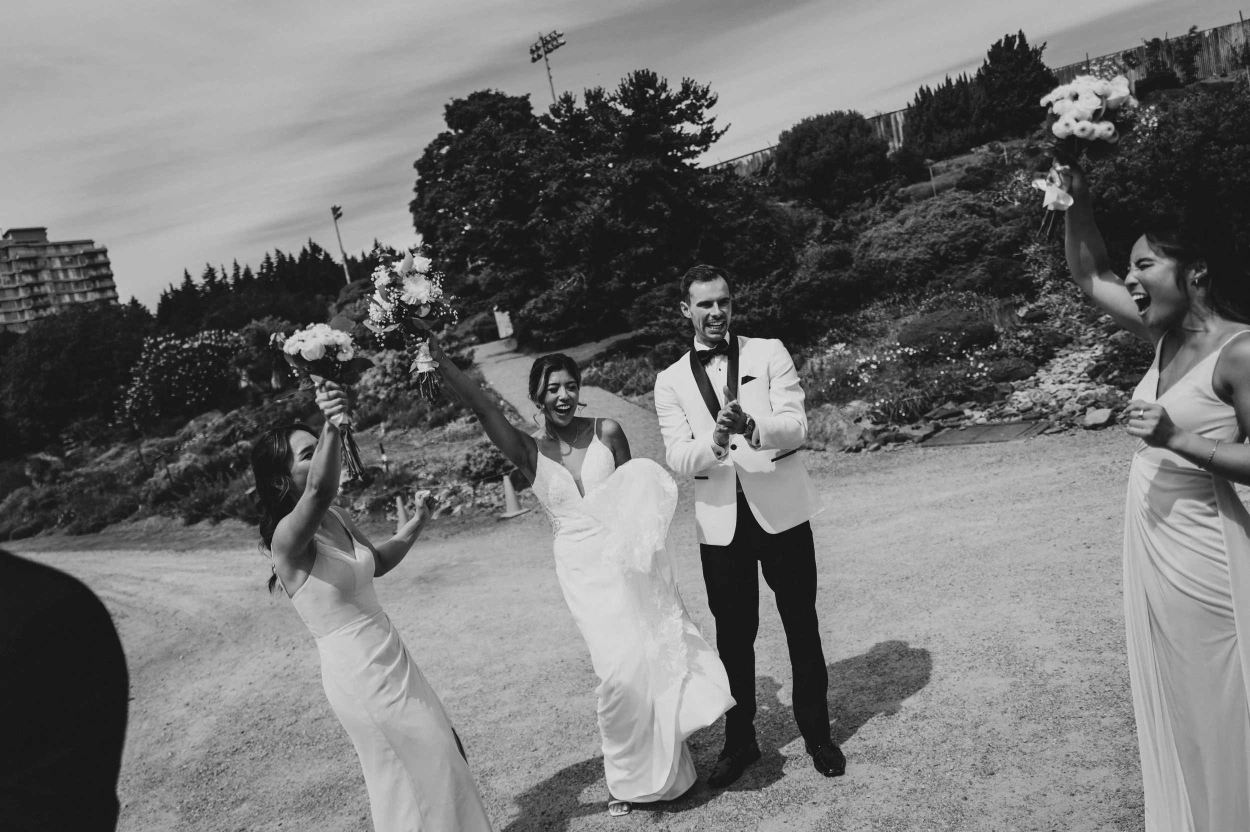 Bride and groom celebrating with their wedding party at UBC Botanical Garden in Vancouver.