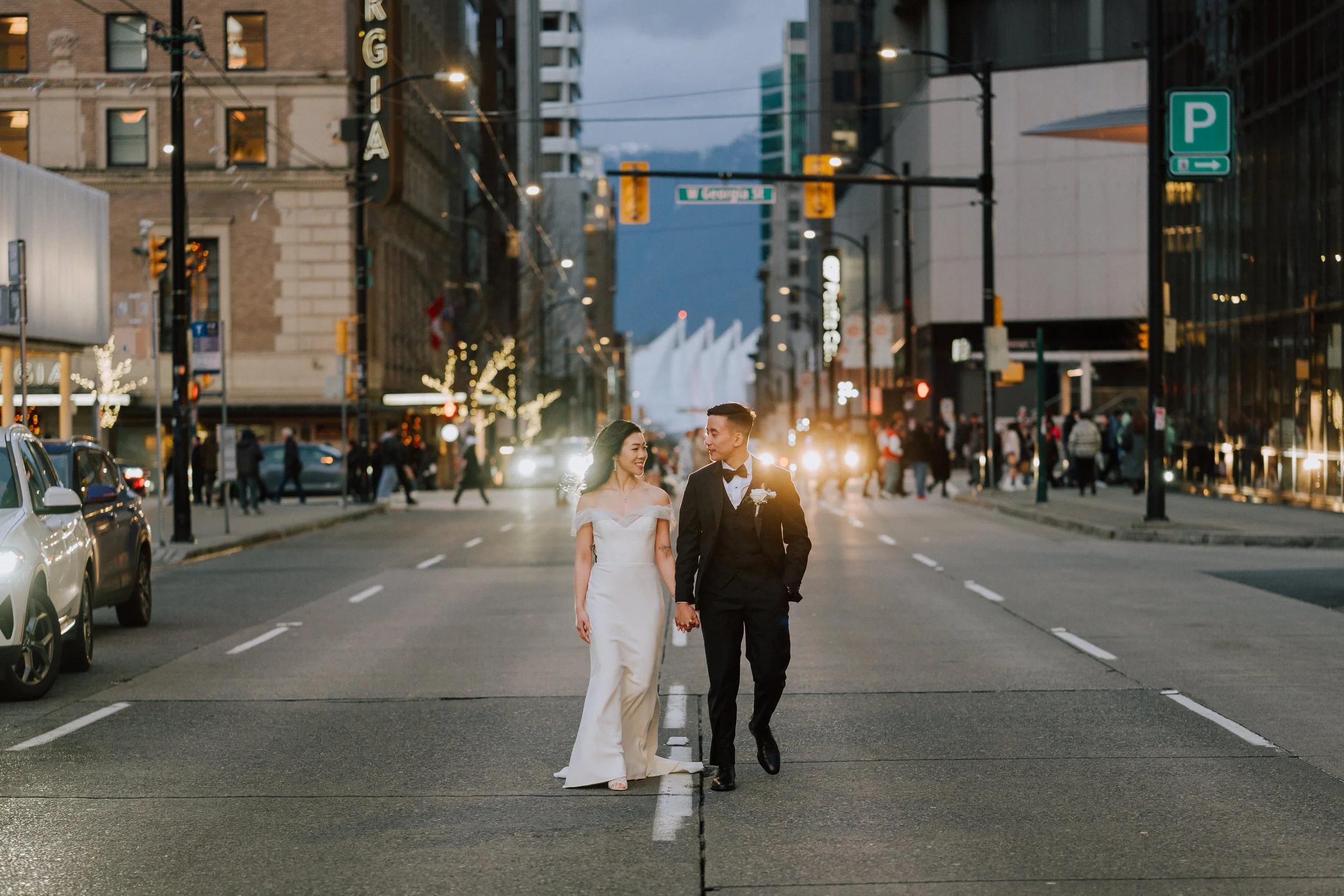 Bride and groom walking through Downtown Vancouver during their wedding portraits.
