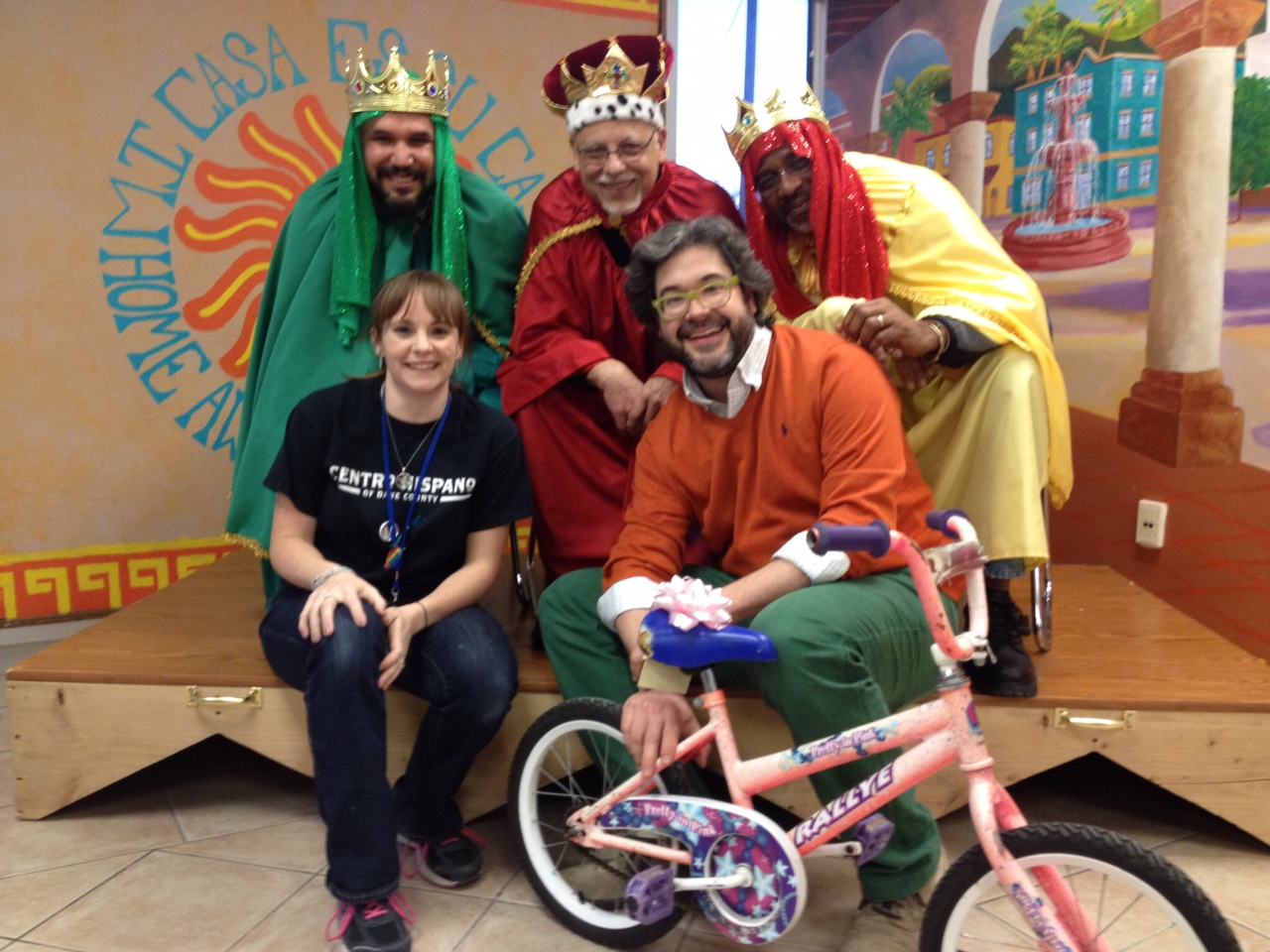 Wheels for Winners partnered with Centro Hispano to give out toddler-sized and small youth bicycles during the 2015 Tres Reyes celebration, held in January. Pictured with the Three Kings are Lauren Deakman, Director of Youth Programs for Centro Hispano and Wheels for Winners Board President Stephen Bagwell.