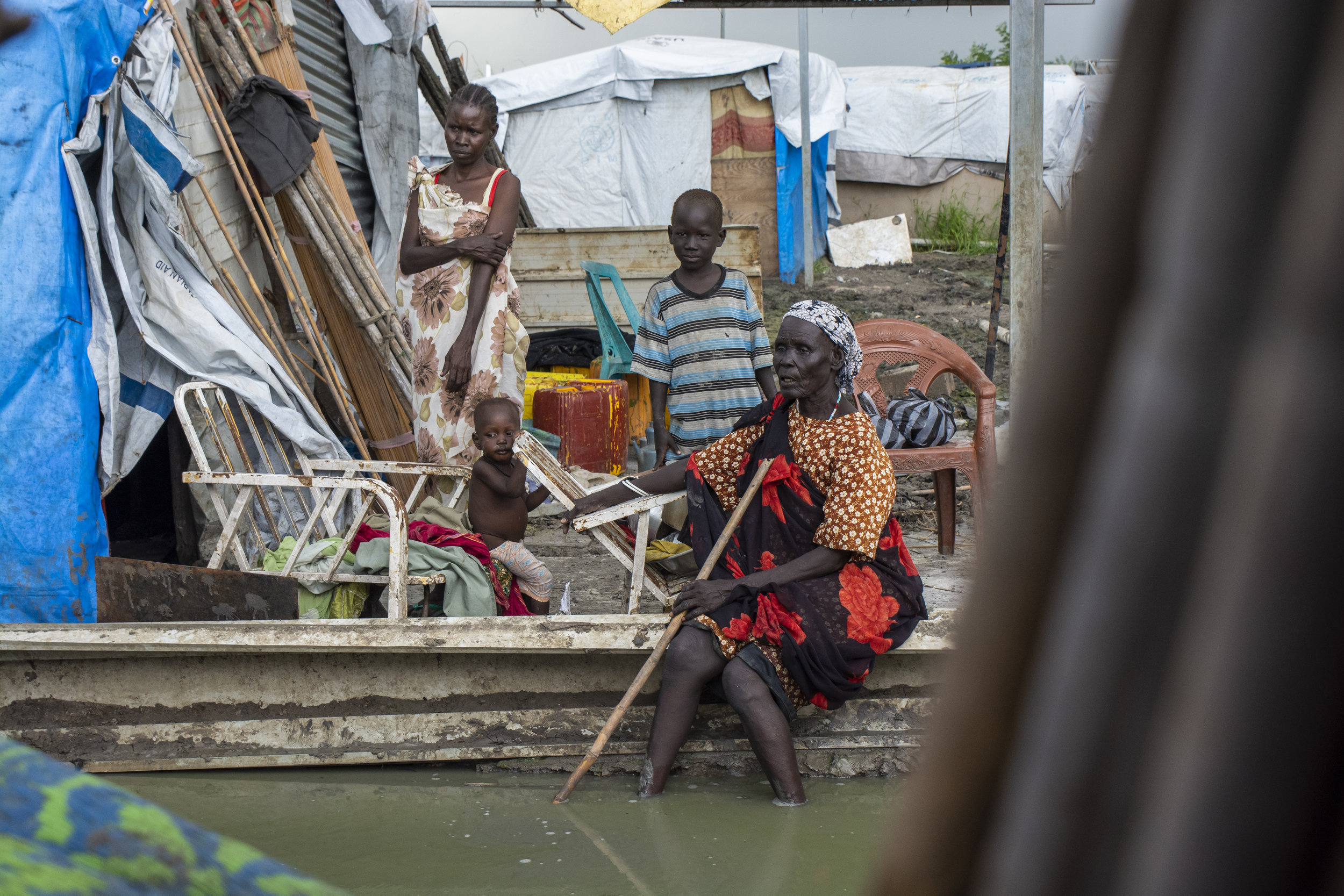  A displaced family next to a makeshift home at the U.N. base in Malakal. Footpaths are submerged for five months of the year during the rainy season. Many of the children here suffer from acute malnutrition and diseases such as tuberculosis. When it