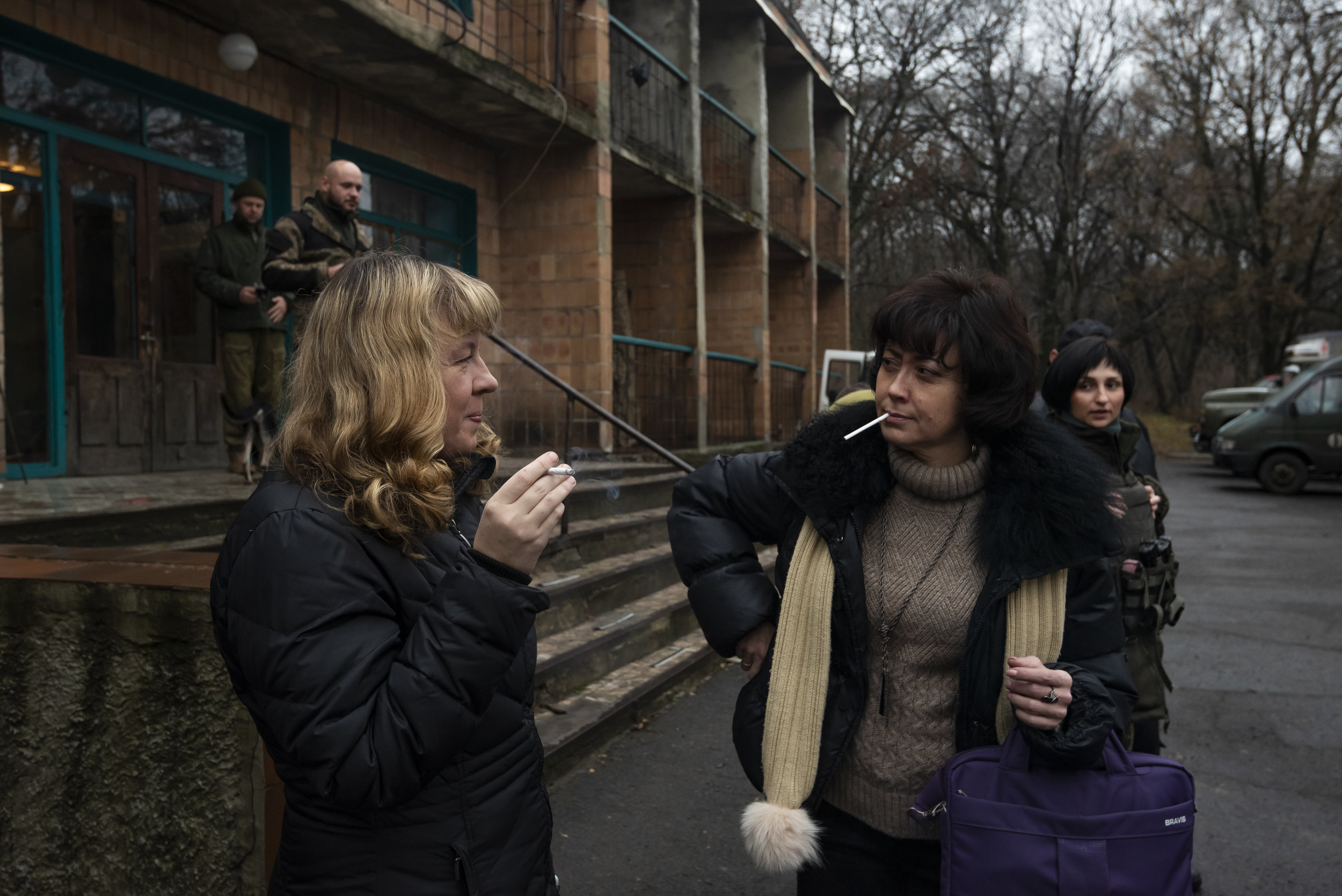  Irina Shopina (left) and Ksenia Ponomarjova, volunteers from Kyiv, get ready for the military escort to Avdiivka. Their mission,  to deliver medical aid to the elderly living on the front line.  