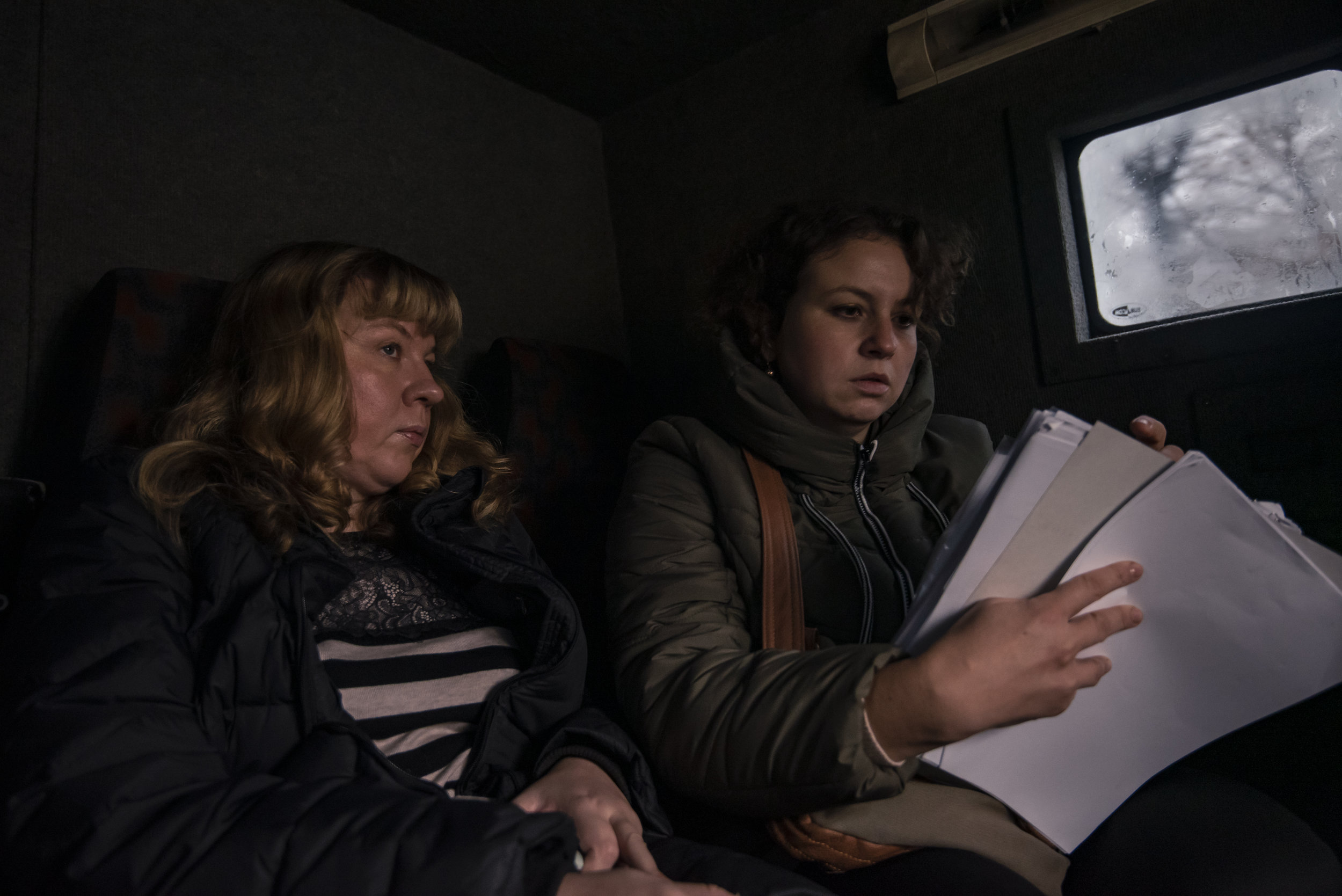  Irina Shopina (left) and Veronika Korol of ICF Res.Publica, a Kyiv-based volunteer group, check their patient lists before delivering medical aid to elderly in the front line town of Avdiivka, Ukraine. 