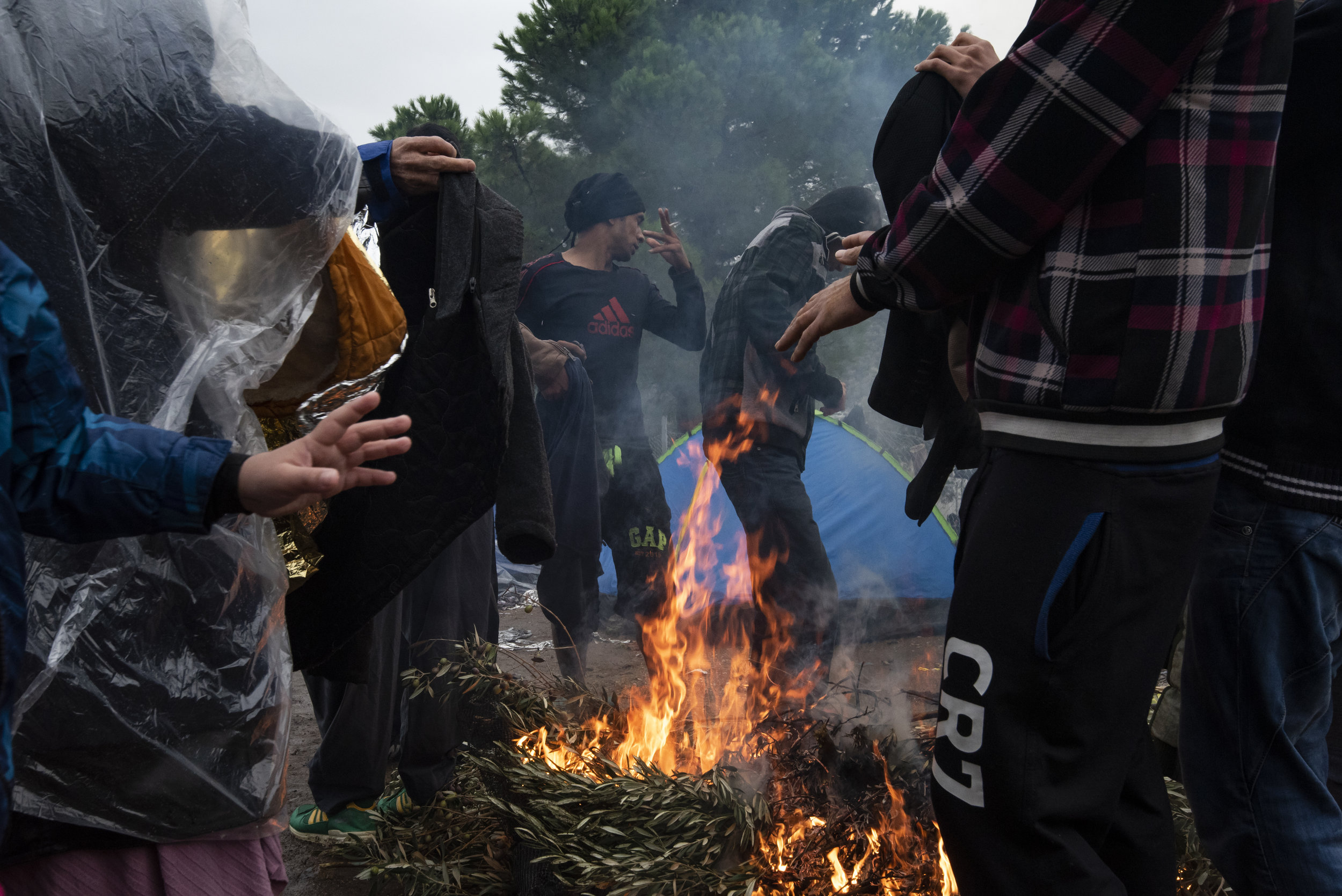  Late October in Lesvos can fluctuate between stifling heat and unremitting rain. Refugees will burn anything they get get their hands on to build a fire, warm up and dry out. 