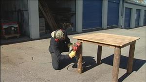 Tennessee Barn Wood's owner, Ray Trotta, finishing up some legs to a beautiful signature table.