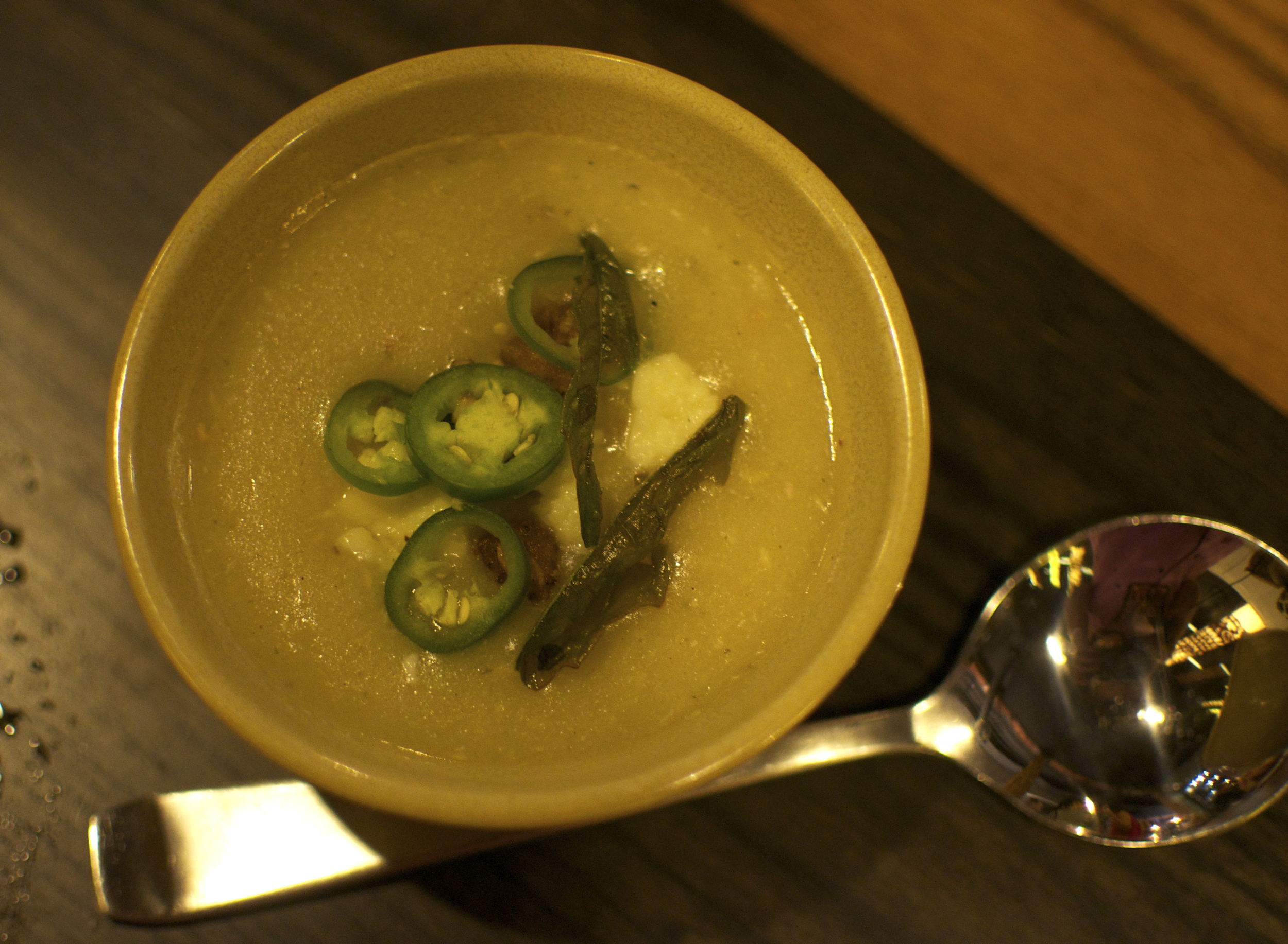 Delicious corn soup topped with a sprinkling of cheese, fried onion, and crunchy little bits - and chile peppers for some added burn