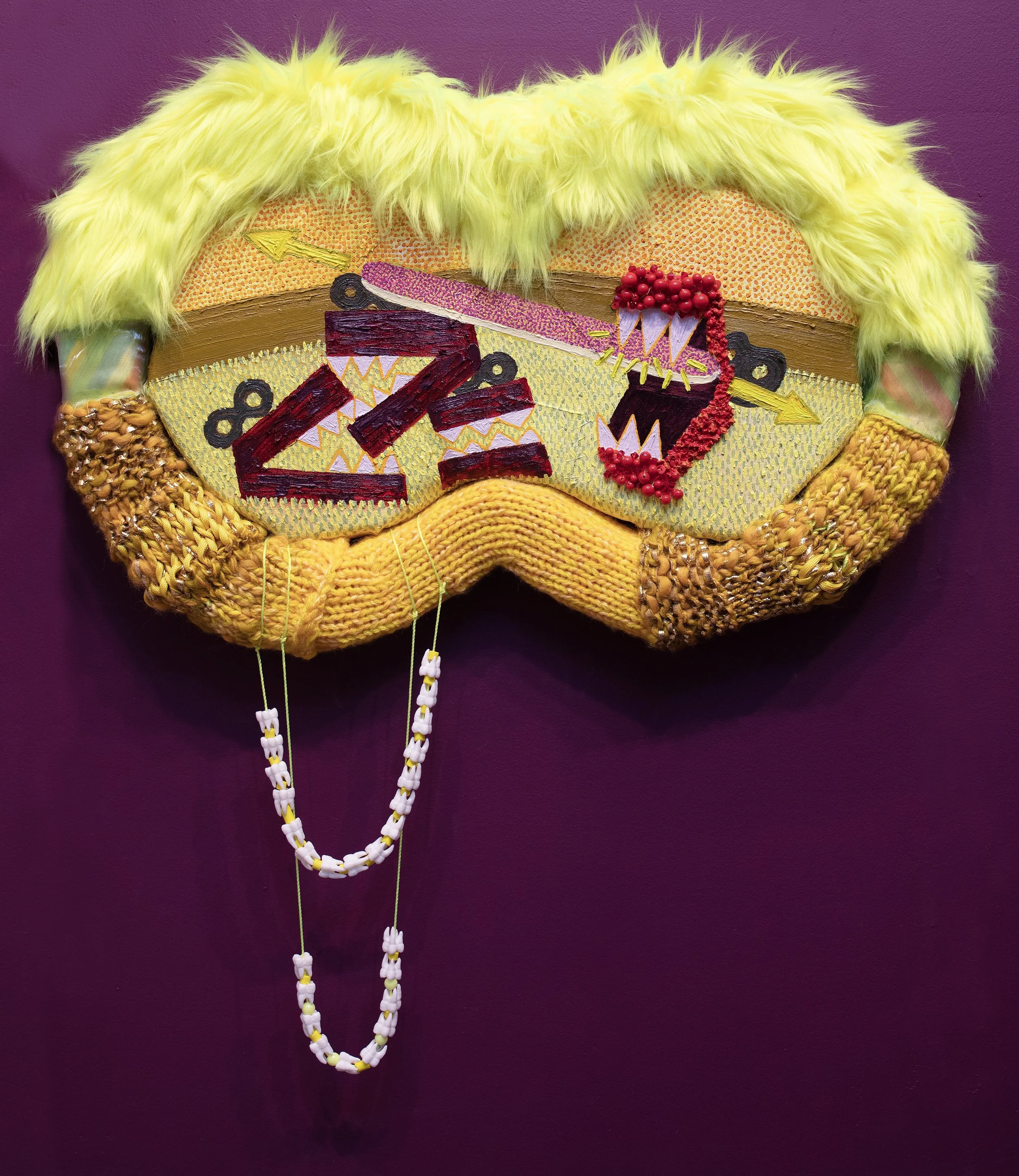 Binocular Viewpoint: Your spit scream upon her face, locked forward by a generation brace  2023  Oil on canvas and textile wrapped upholstery foam, beads and plastic teeth  18 in x 24 in x 3 in