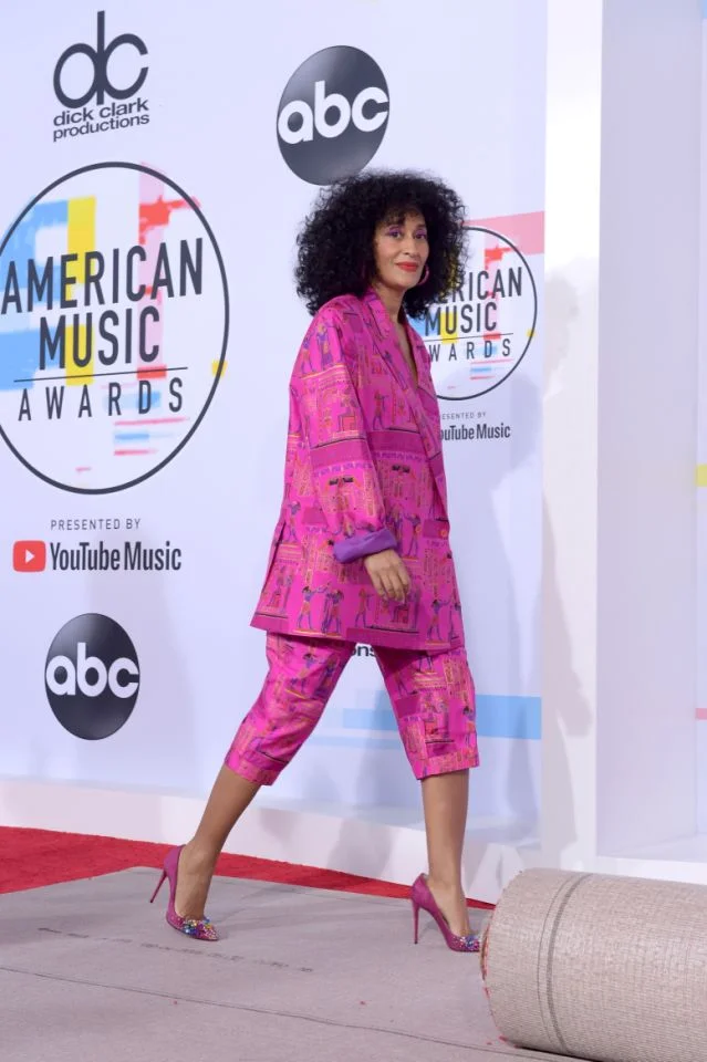 PHOTO: GETTY Always a pink moment! She wore Amsterdam-based designer Selam Fessahaye pink suit with Egyptian hieroglyphics to the AMAs rehearsals paired with pink Jimmy Choos.
