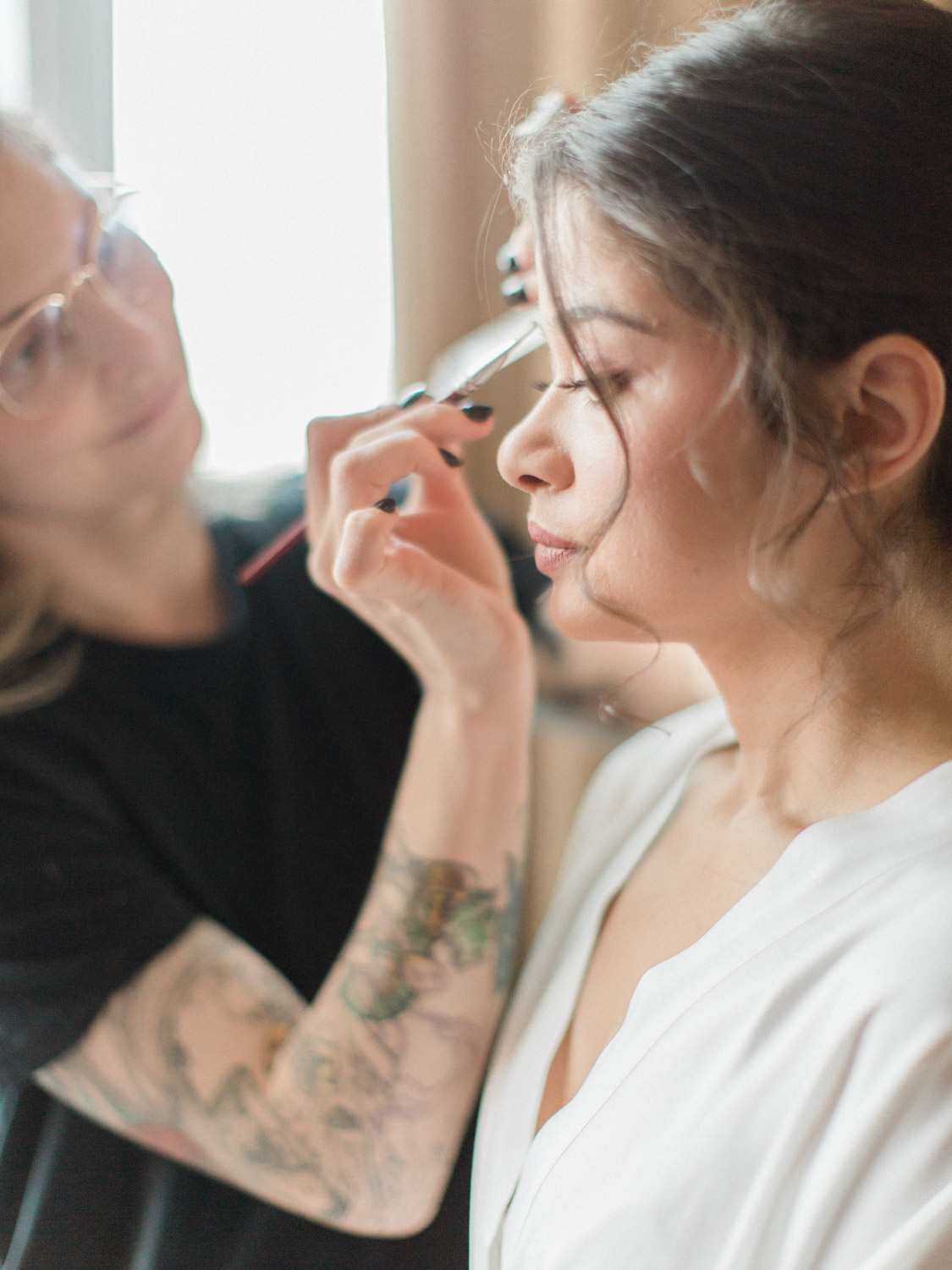 - Natural, candid photograph of bridesmaids and bride getting ready for a winter wedding at Ritz Carlton in Toronto. Captured by Toronto wedding photographer Corynn Fowler Photography.