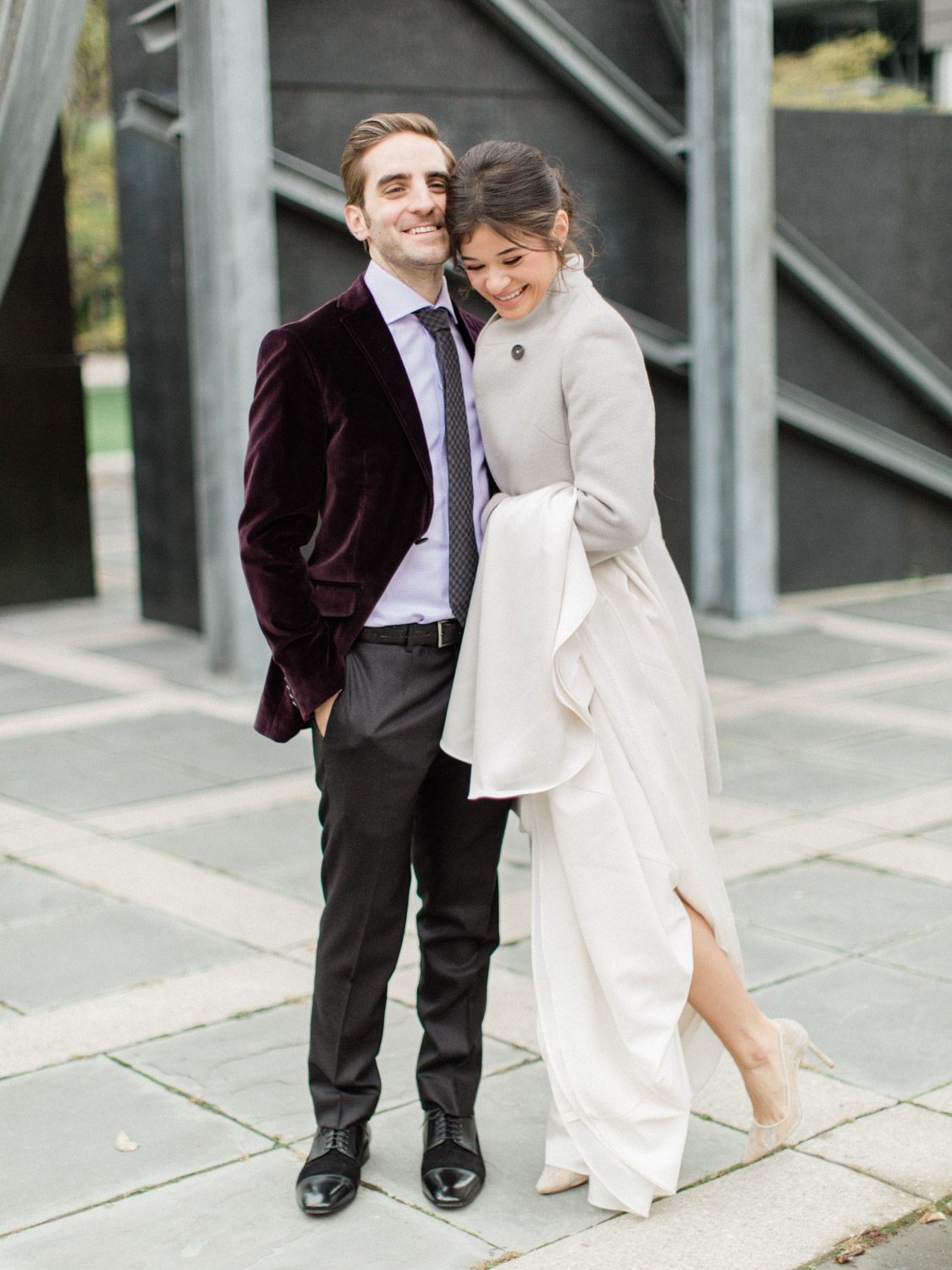 - candid photograph of bride and groom laughing while posing for wedding photographs in Downtown Toronto. Captured by Toronto wedding photographer Corynn Fowler Photography.