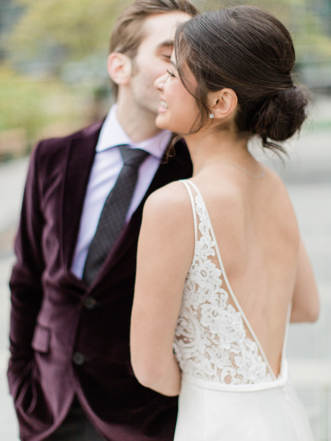 - candid photograph of bride and groom laughing while posing for wedding photographs in Downtown Toronto. Captured by Toronto wedding photographer Corynn Fowler Photography.