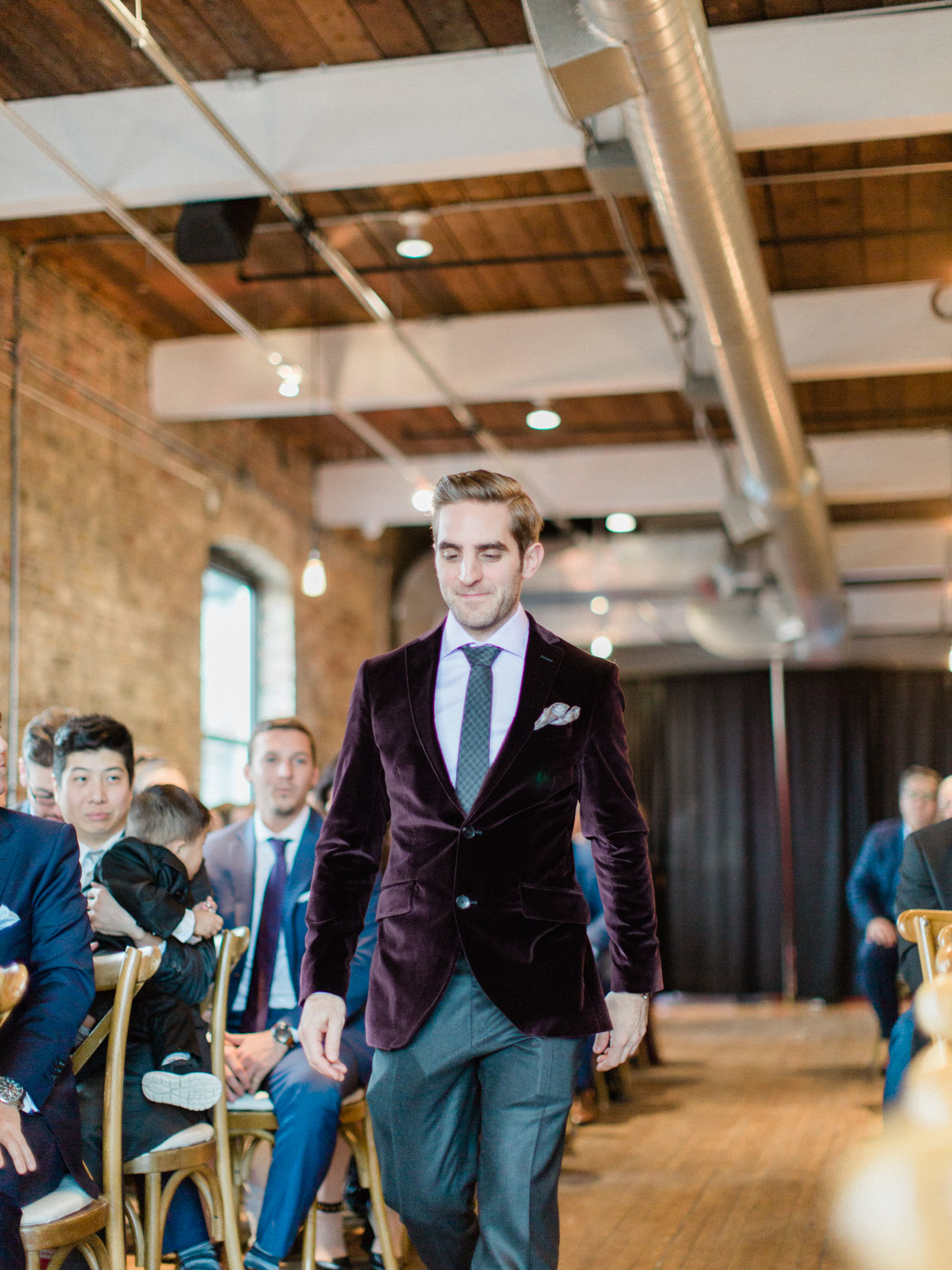 Candid, emotional photograph of indoor winter wedding ceremony at The Burroughes venue in Toronto. Captured by Toronto wedding photographer Corynn Fowler Photography.
