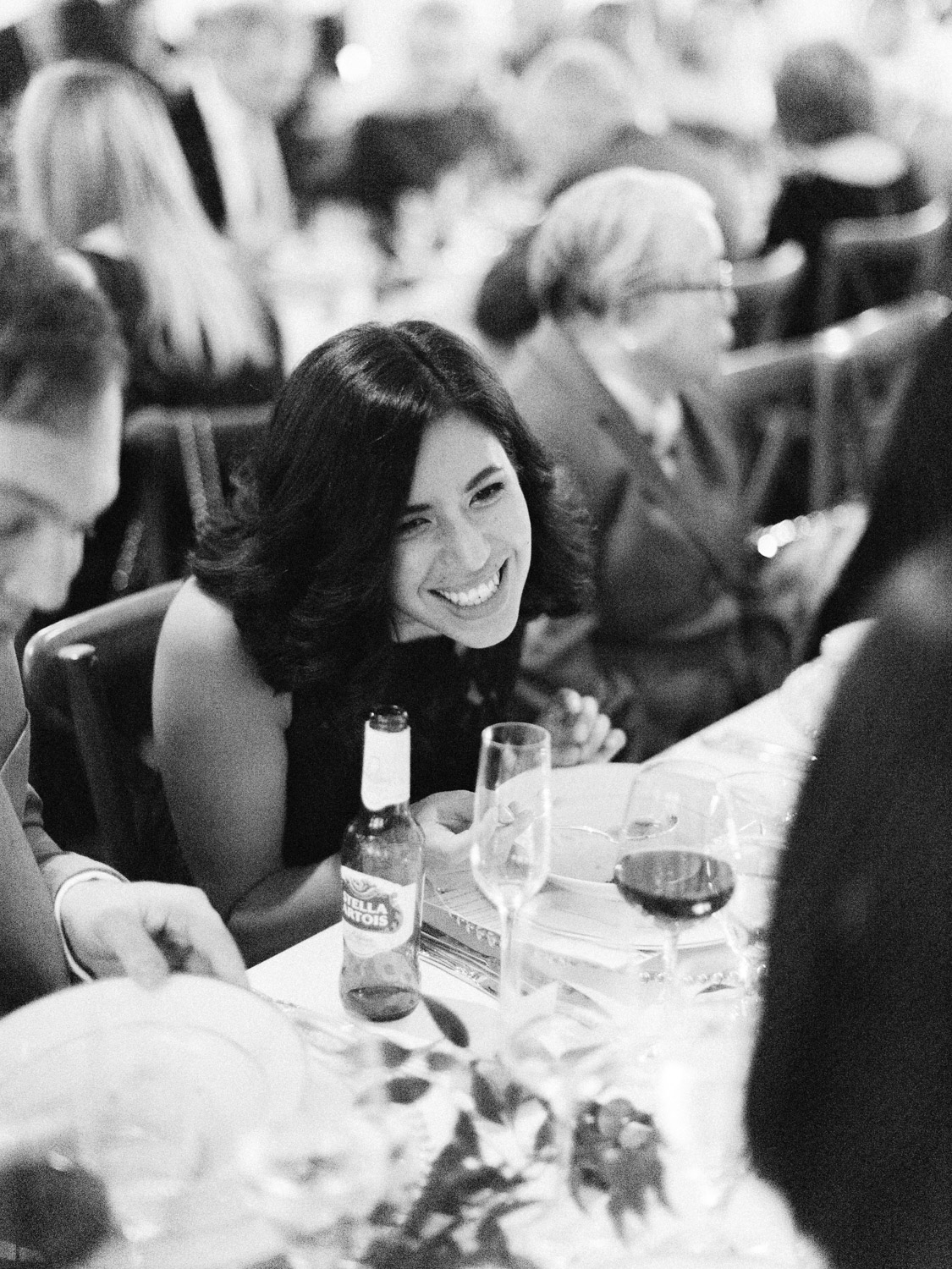 Candid wedding photograph of guests, bride and groom enjoying the reception at Italian wedding at The Burroughes. Captured by Toronto wedding photographer Corynn Fowler Photography.