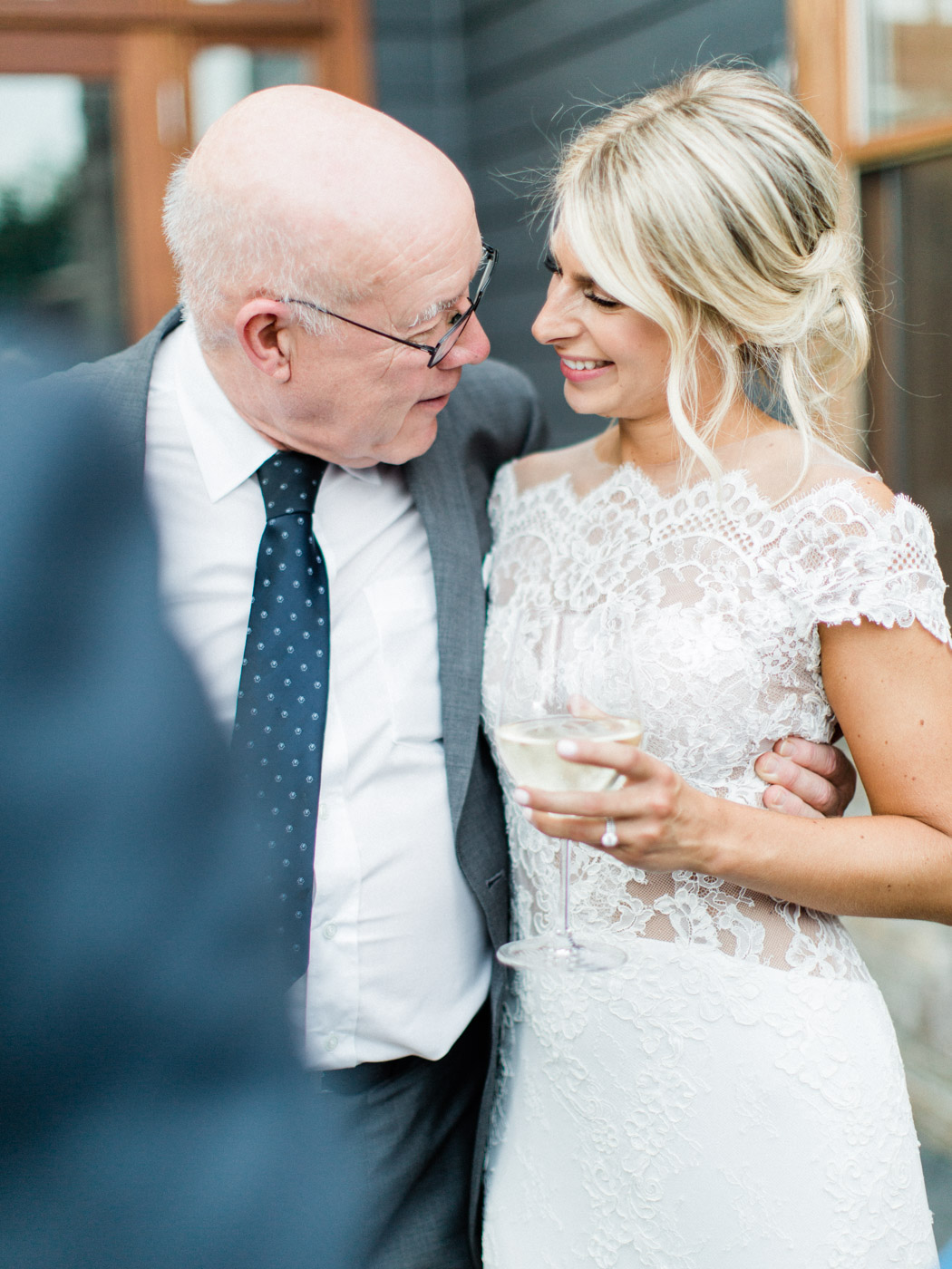 Candid documentary photograph of guests and couple at outdoor reception in Muskoka. Captured by wedding photographer Corynn Fowler Photography.