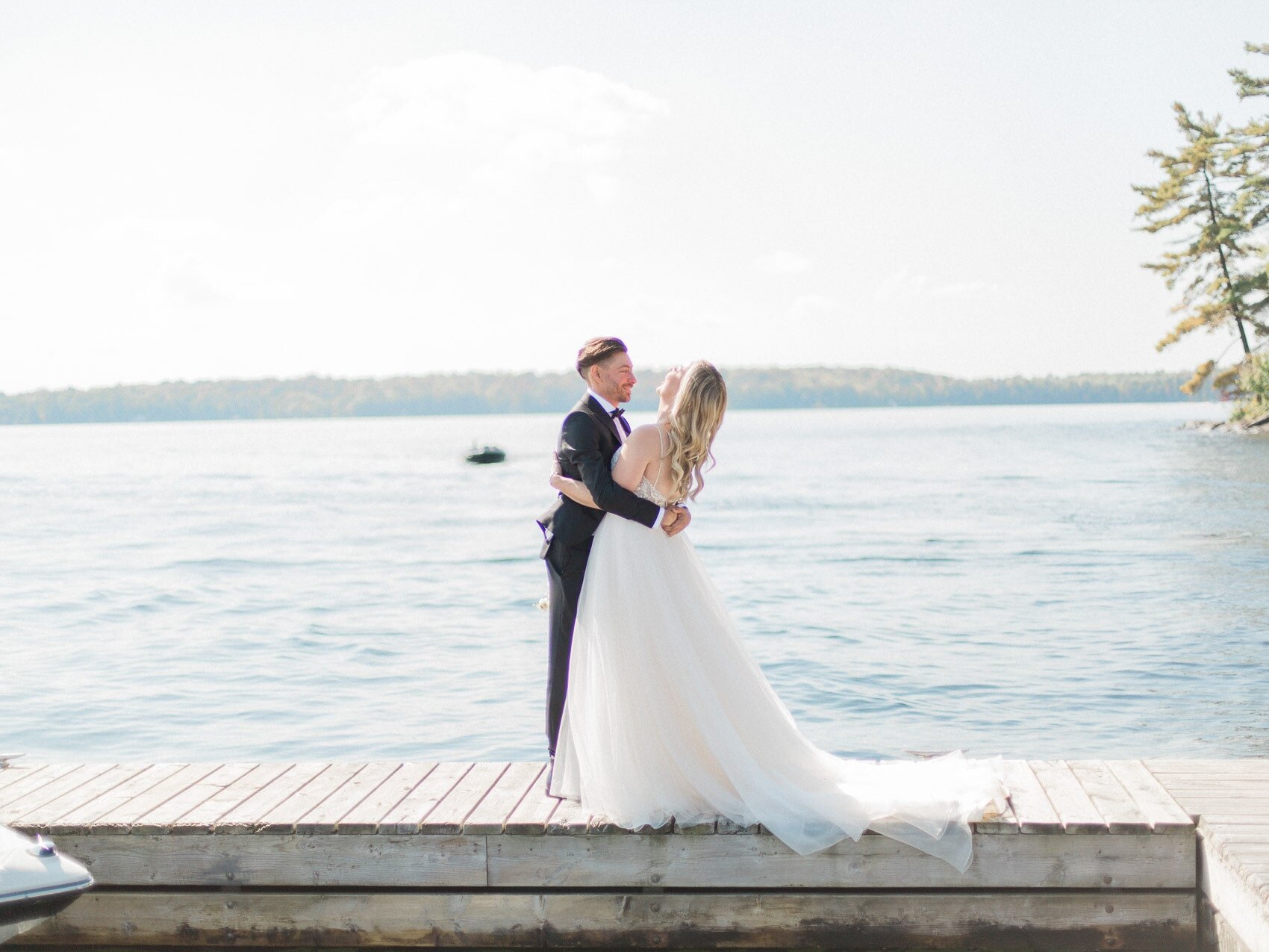 candid and emotional first look between bride and groom on the dock at windermere house muskoka