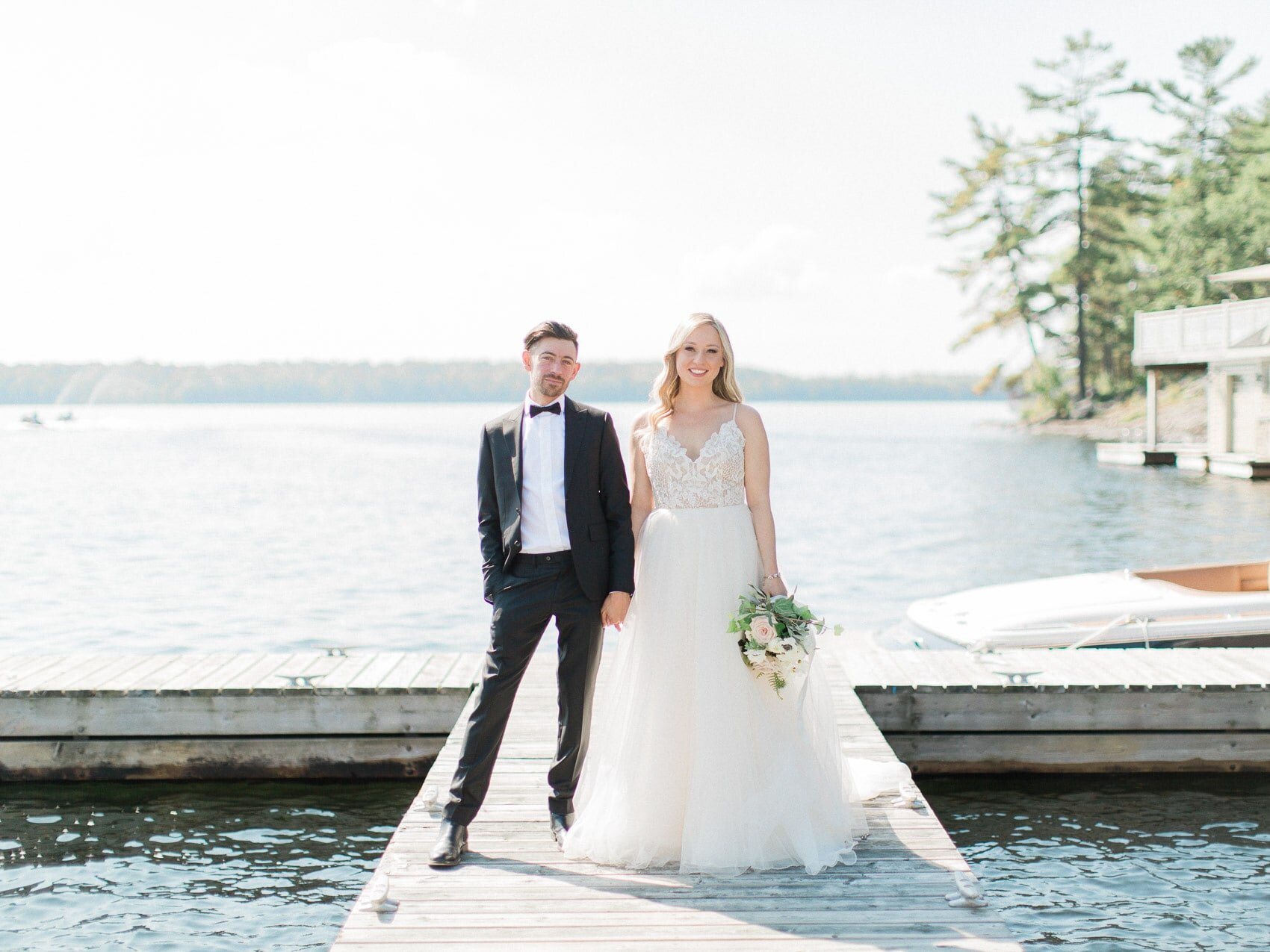 bride and groom posing naturally for a candid happy photo on their wedding day at windermere house muskoka