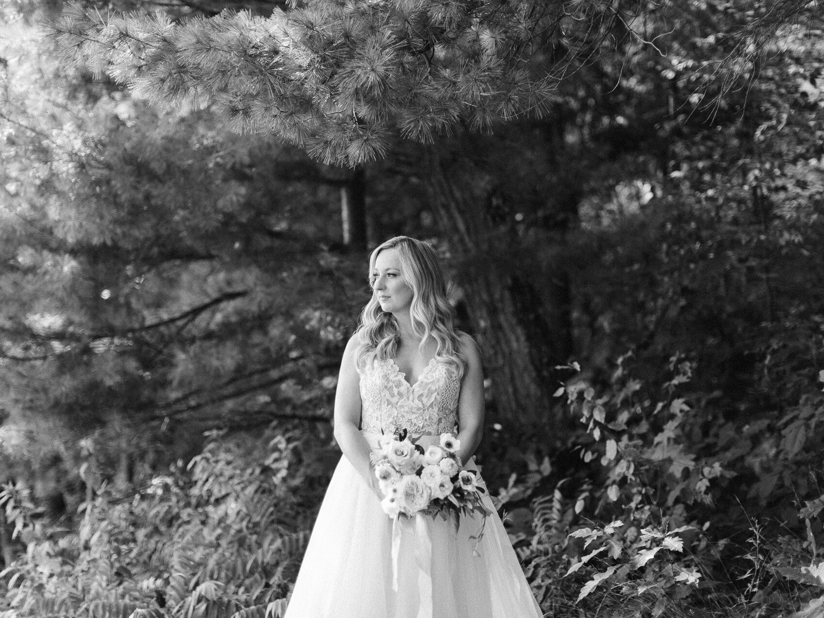 bride posing naturally for a candid happy photo on her wedding day at windermere house muskoka