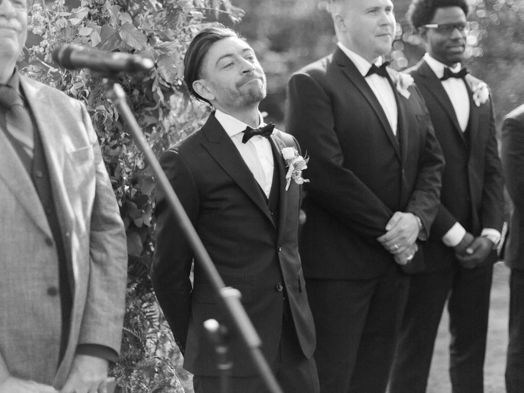 natural candid photo of the groom at his outdoor wedding ceremony at windermere house muskoka