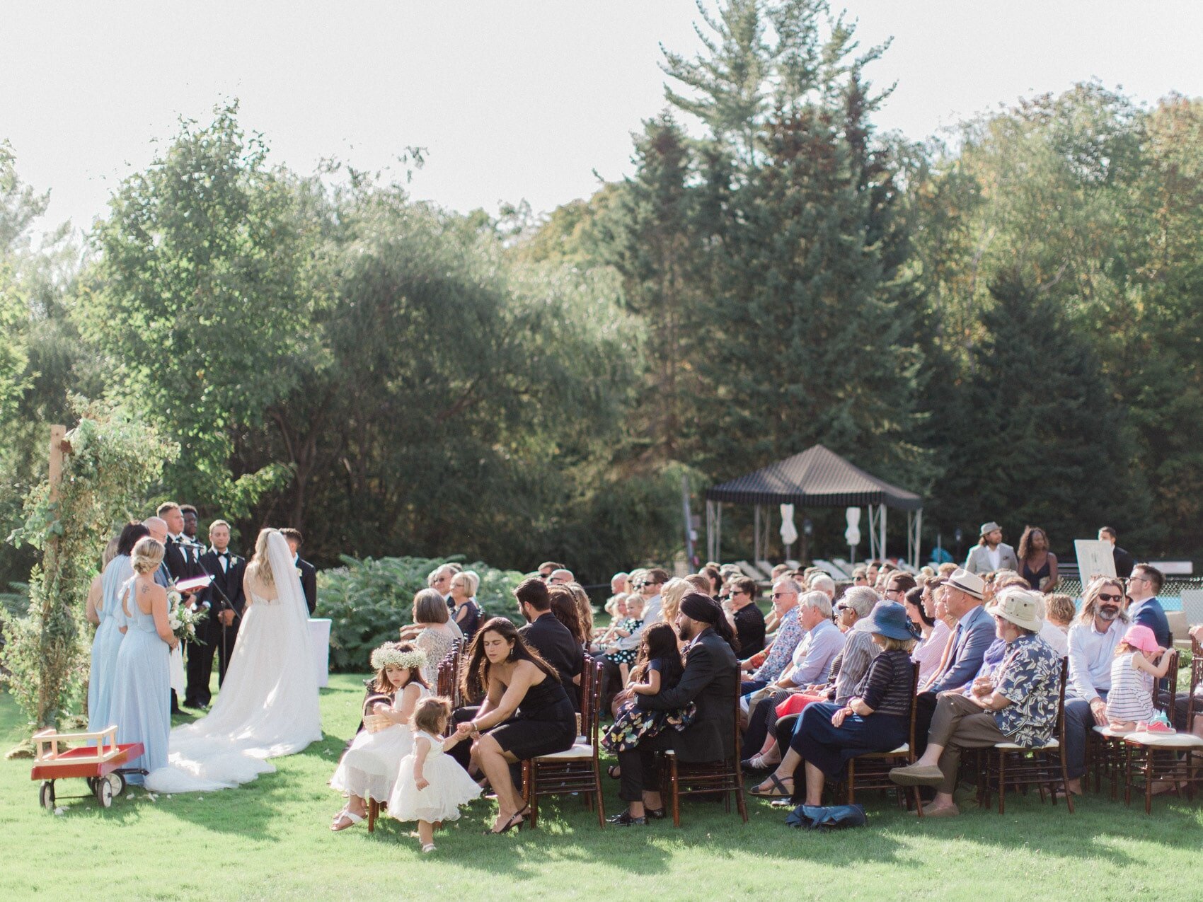 natural candid photo of the bride and groom at their outdoor wedding ceremony at windermere house muskoka