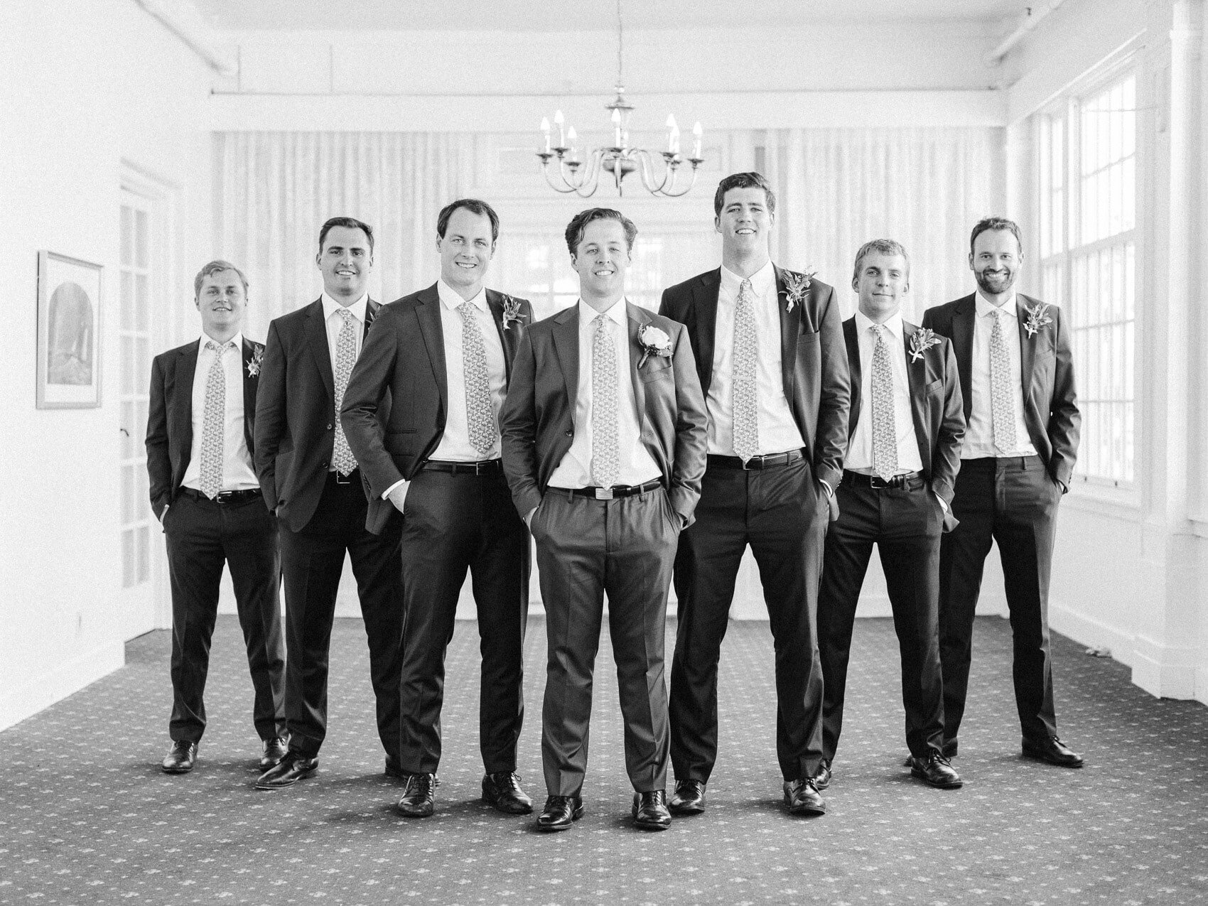 groomsmen posing naturally for a candid photograph at the rcyc toronto