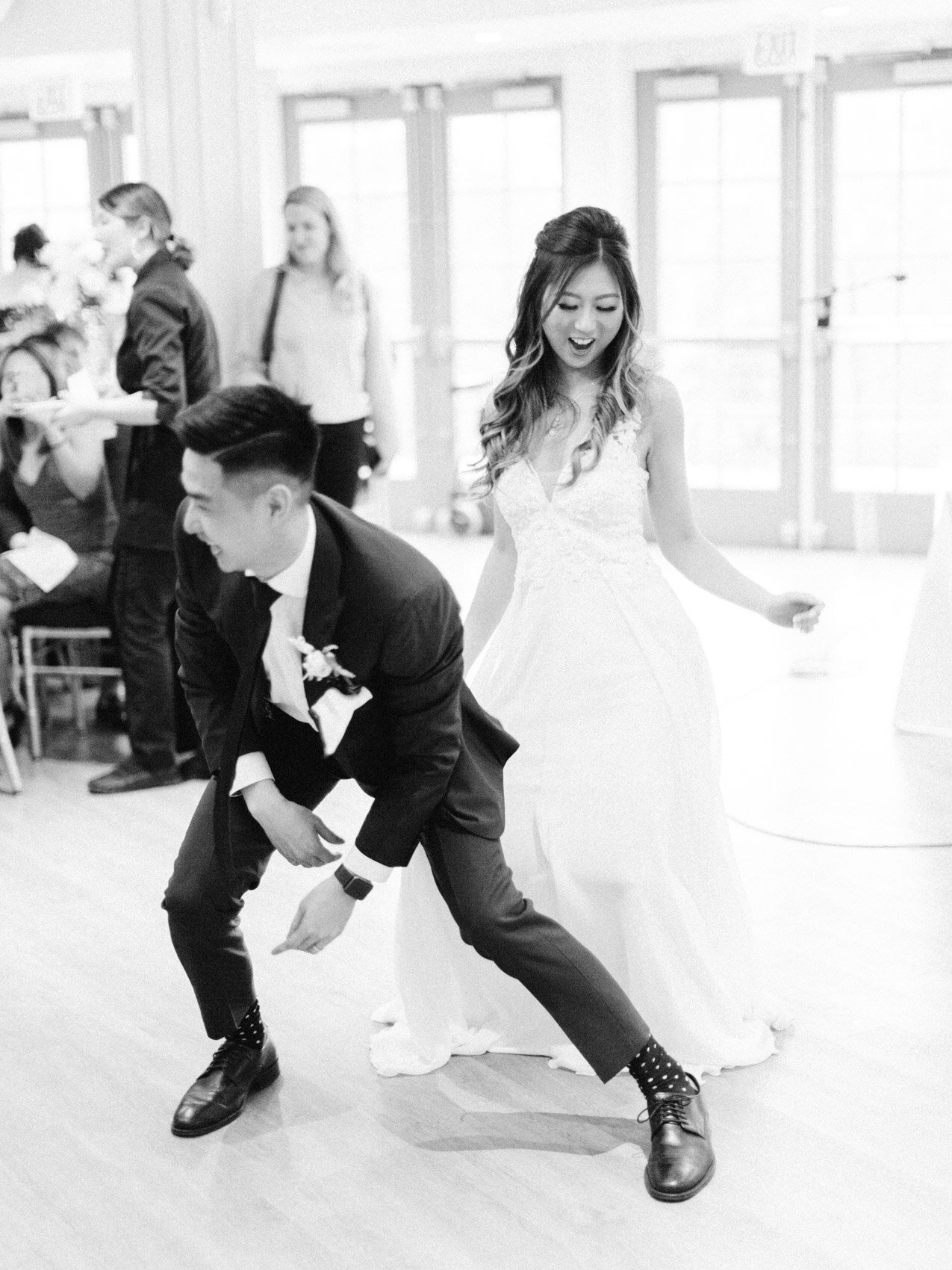 bride and groom dancing for their reception games as part of their chinese wedding at the doctors house in kleinburg