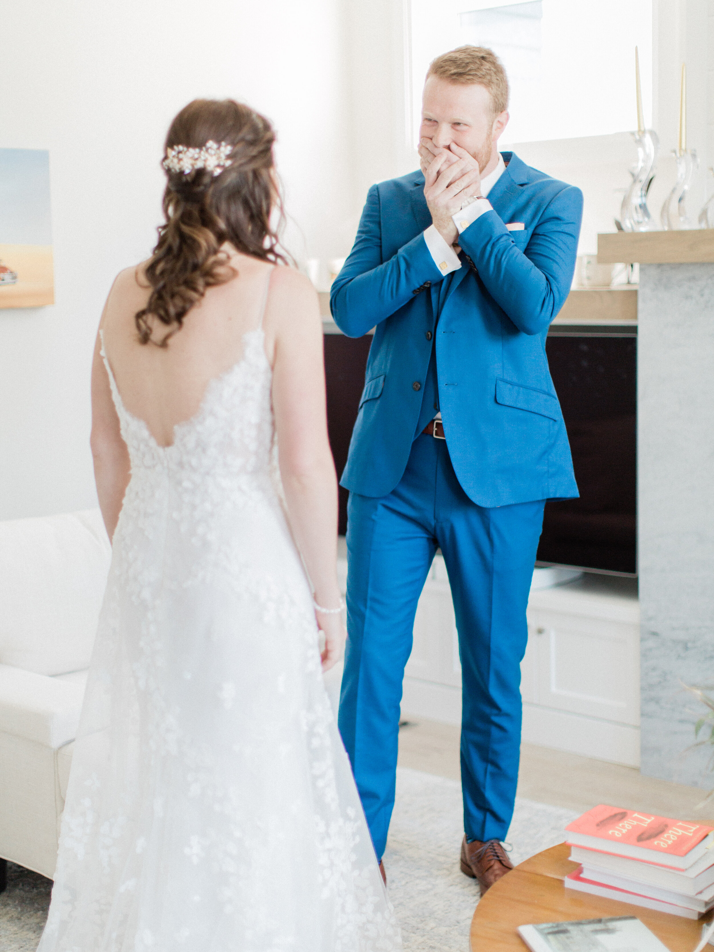 groom reacting to seeing his bride at their emotional first look