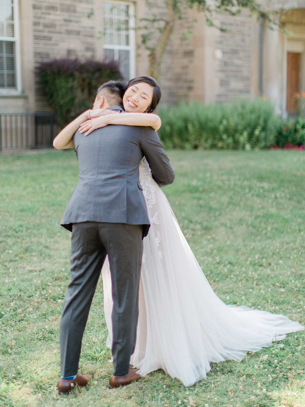 bride and groom hugging at their first look at the dunlap observatory