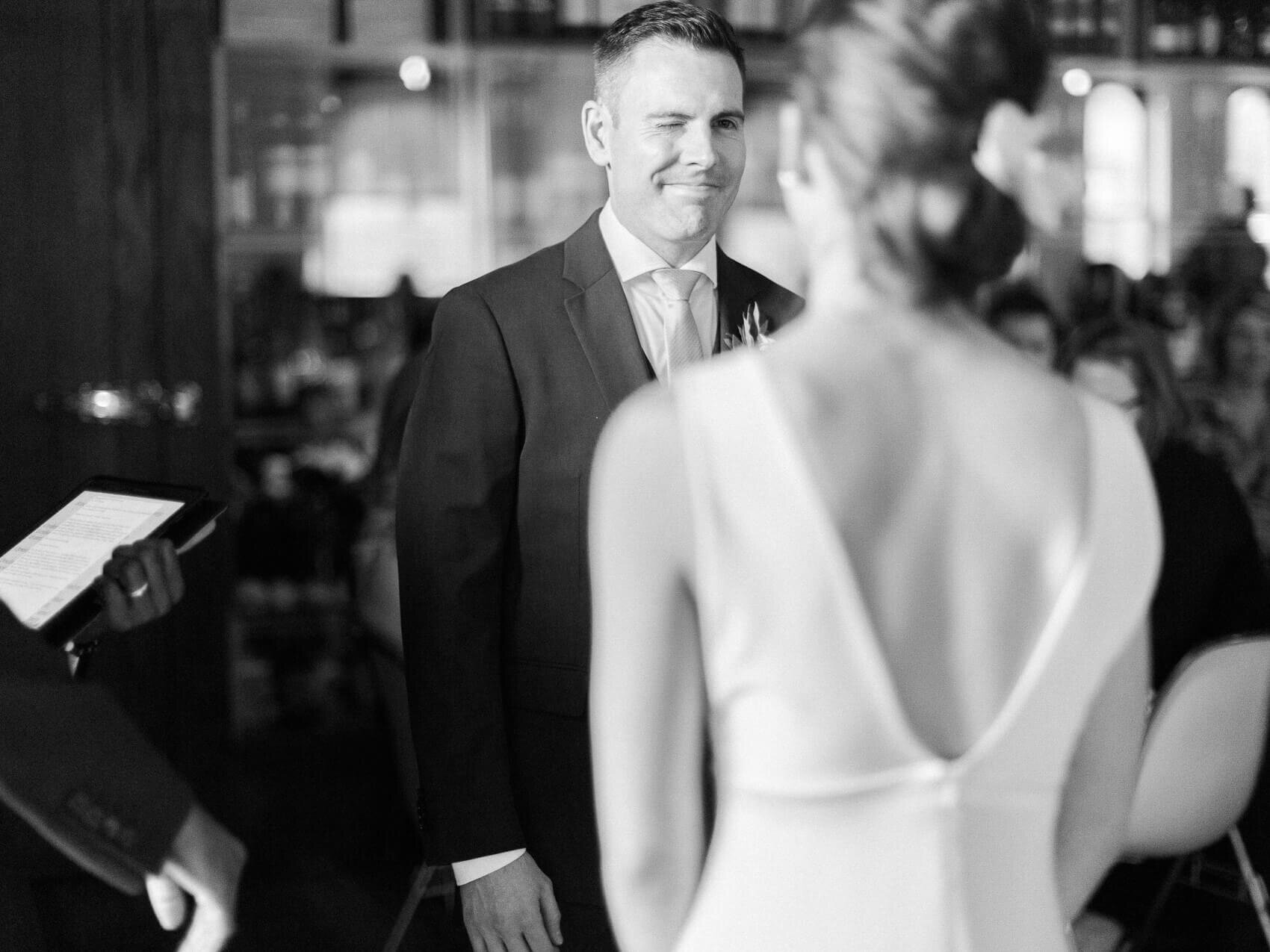 candid moment during the wedding ceremony at an intimate terroni restaurant elopement