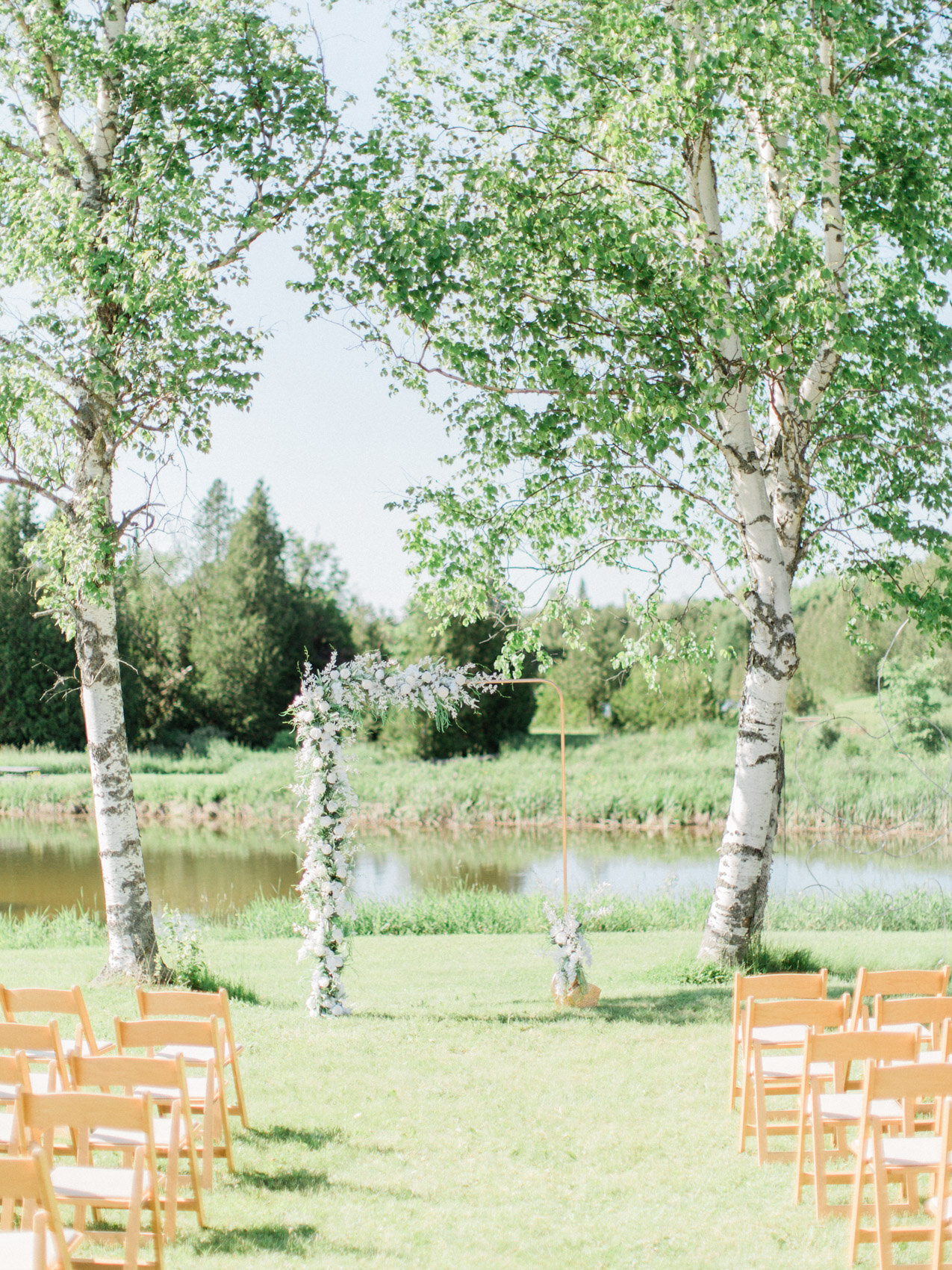 green and white floral arch at an outdoor summer wedding at silver springs retreat