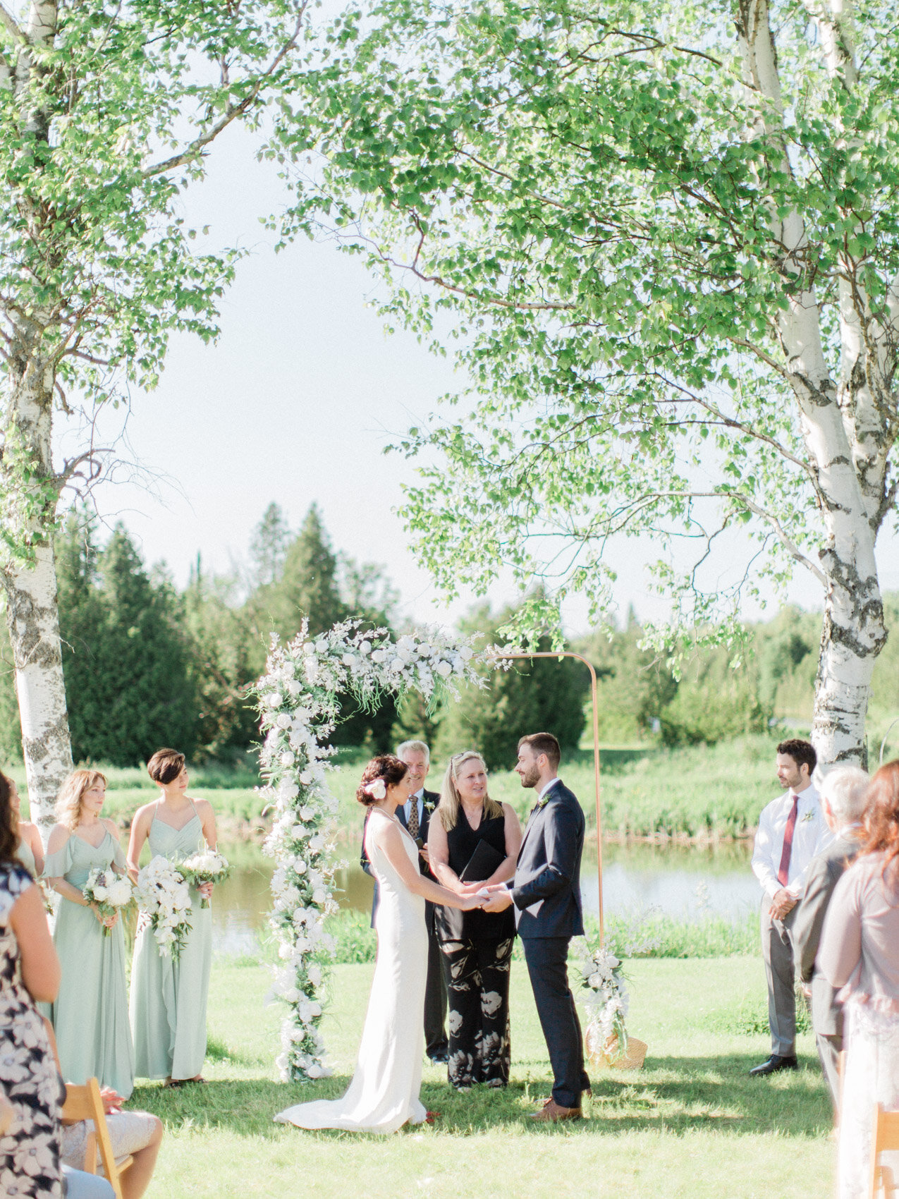 candid photo of outdoor summer wedding ceremony at silver springs retreat