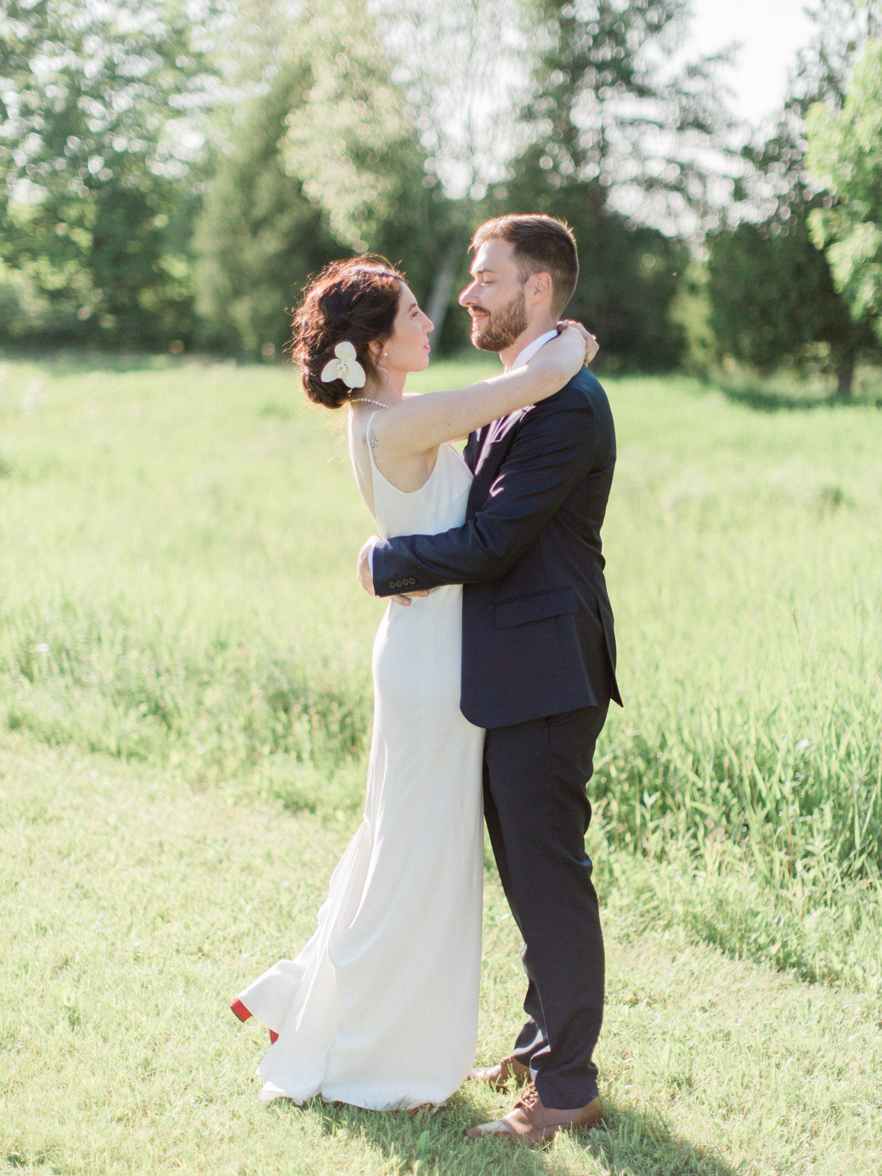 bride and groom posing naturally for their outdoor summer wedding at silver springs retreat