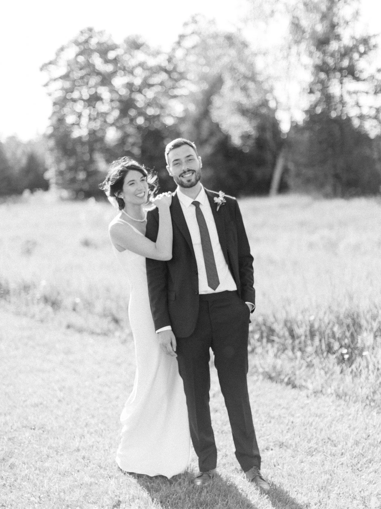 bride and groom posing naturally for their outdoor summer wedding at silver springs retreat